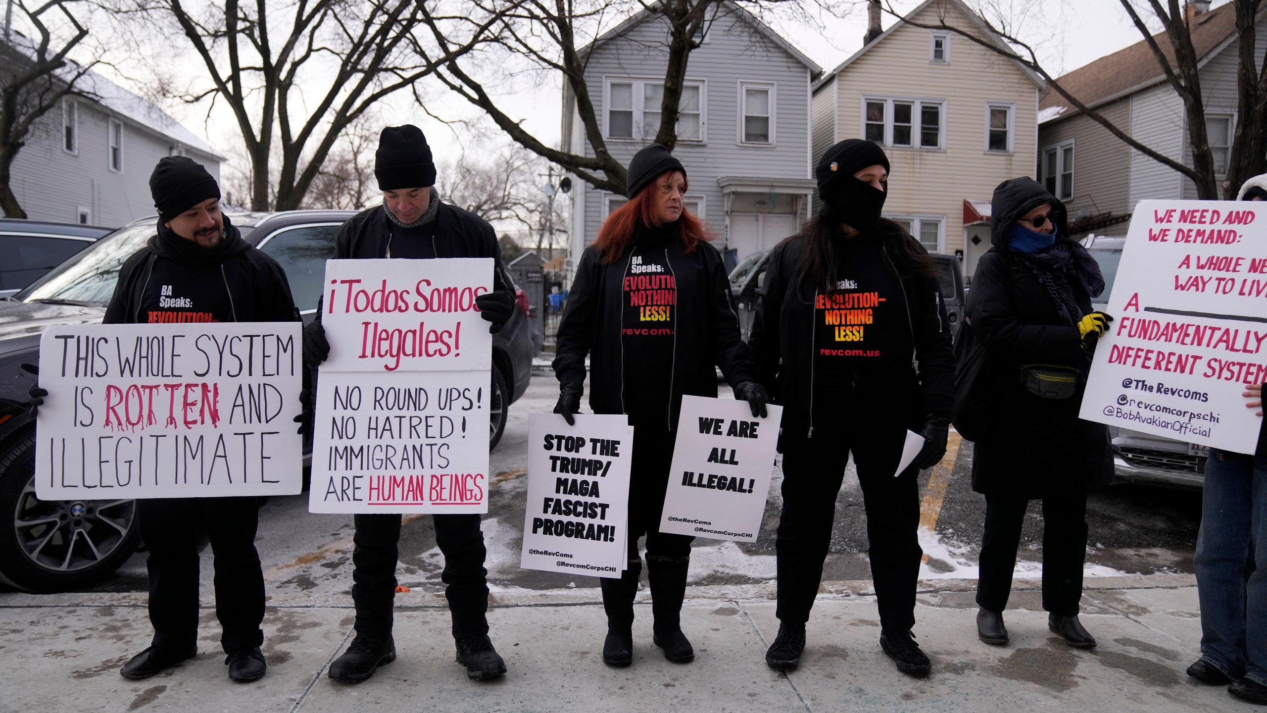 FILE - Activists with Revcom Corps Chicago hold signs outside of Hamline Elementary School after federal agents were turned away on Jan. 24, 2025, in Chicago. (AP Photo/Erin Hooley, file)