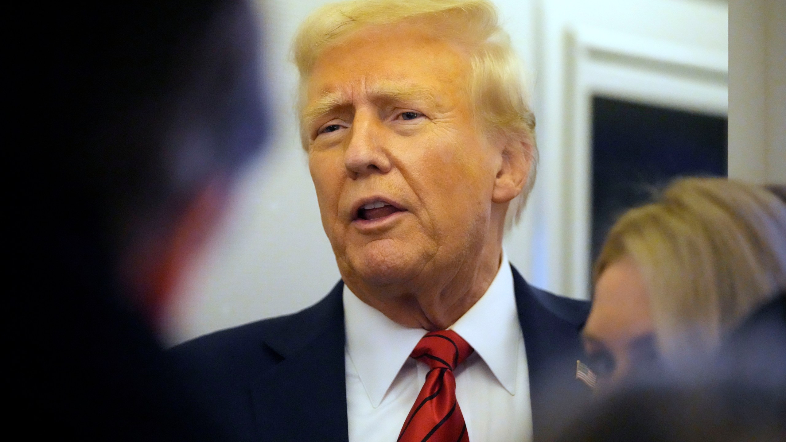 President Donald Trump speaks to reporters aboard Air Force One en route from Miami to Joint Base Andrews, Md., Monday, Jan. 27, 2025. (AP Photo/Mark Schiefelbein)
