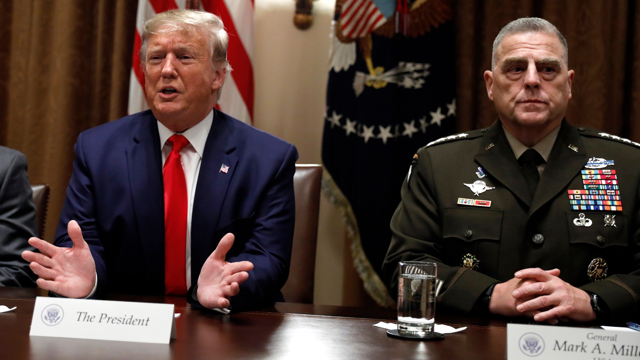 FILE - President Donald Trump speaks as the Chairman of the Joint Chiefs of Staff Gen. Mark Milley, right, listens during a briefing with senior military leaders in the Cabinet Room at the White House in Washington, Monday, Oct. 7, 2019. (AP Photo/Carolyn Kaster, File)
