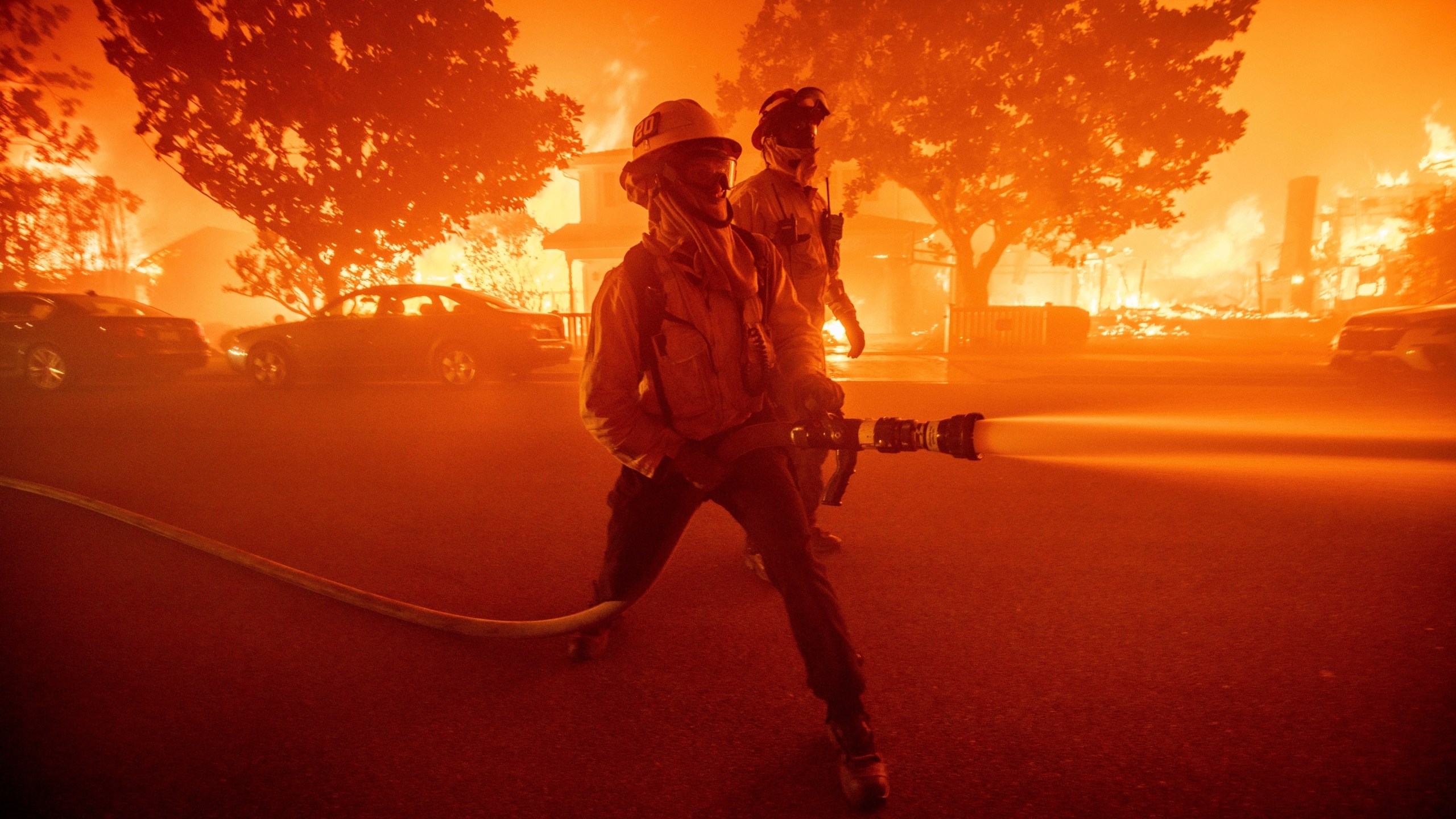 FILE - Firefighters battle the Palisades Fire as it burns multiple structures in the Pacific Palisades neighborhood of Los Angeles, Tuesday, Jan. 7, 2025. (AP Photo/Ethan Swope, File)