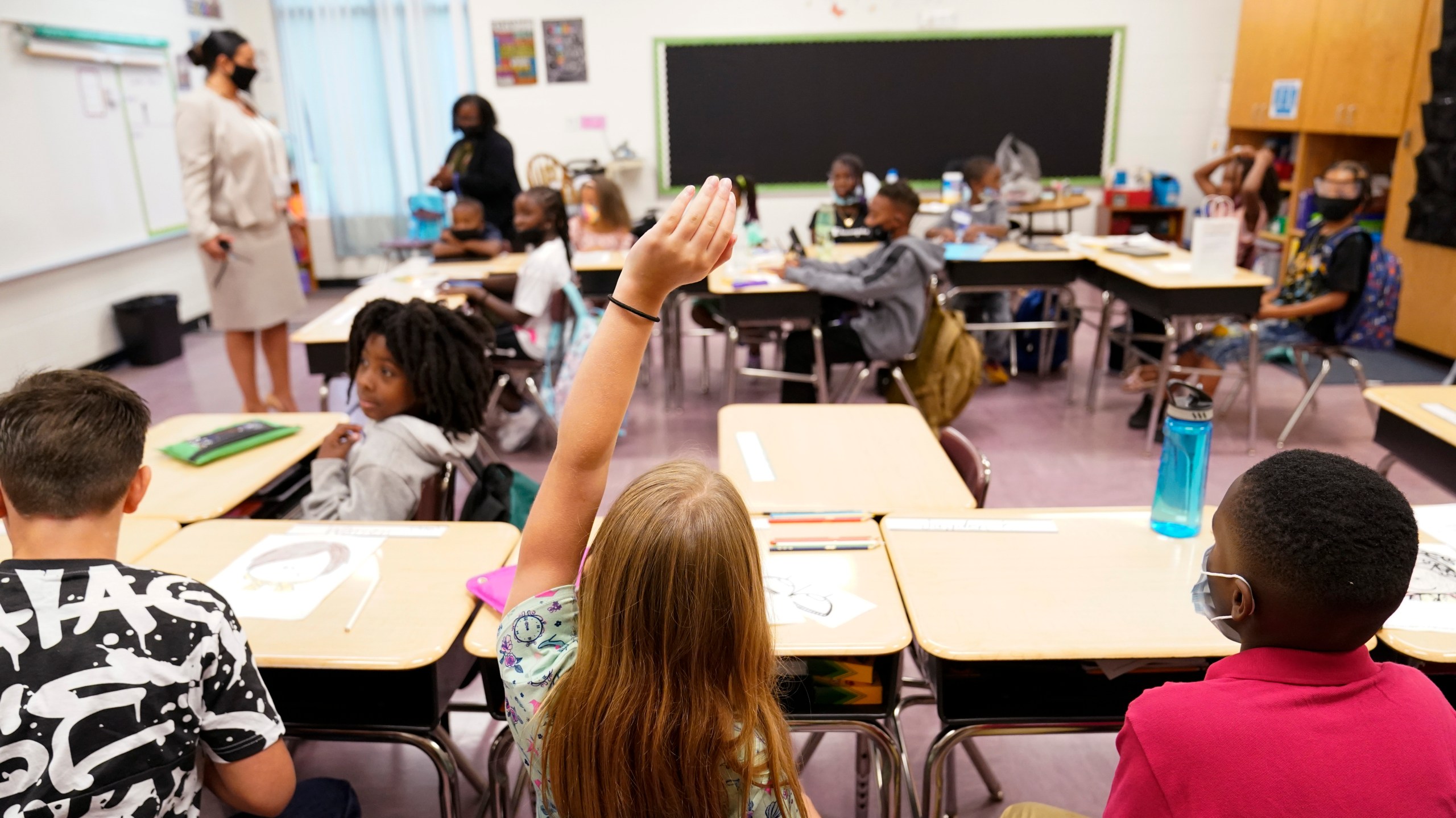 FILE - A student raises their hand in a classroom at Tussahaw Elementary school Aug. 4, 2021, in McDonough, Ga. (AP Photo/Brynn Anderson, File)