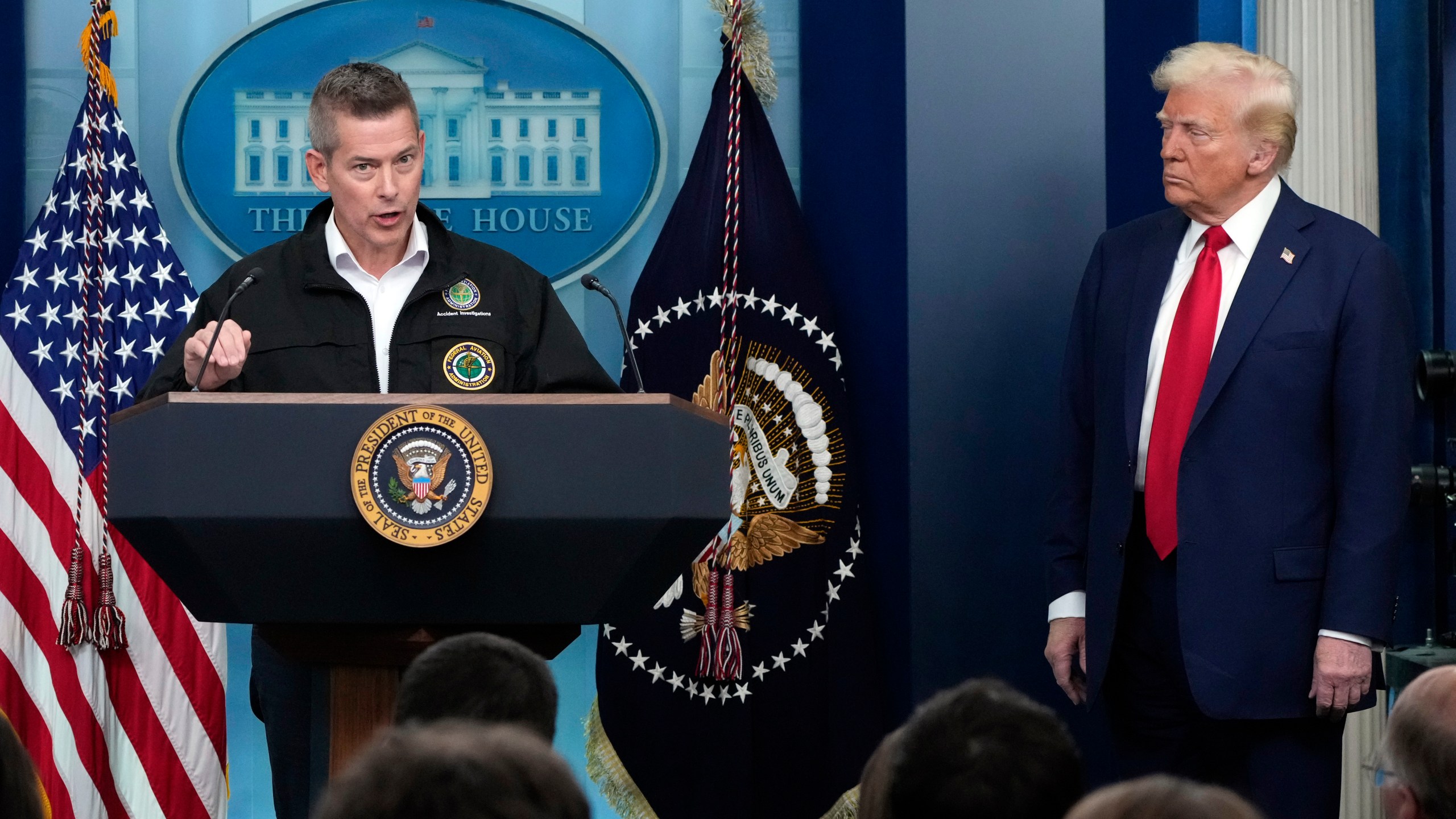 President Donald Trump listens as Transportation Secretary Sean Duffy speaks in the James Brady Press Briefing Room at the White House, Thursday, Jan. 30, 2025, in Washington. (AP Photo/Alex Brandon)