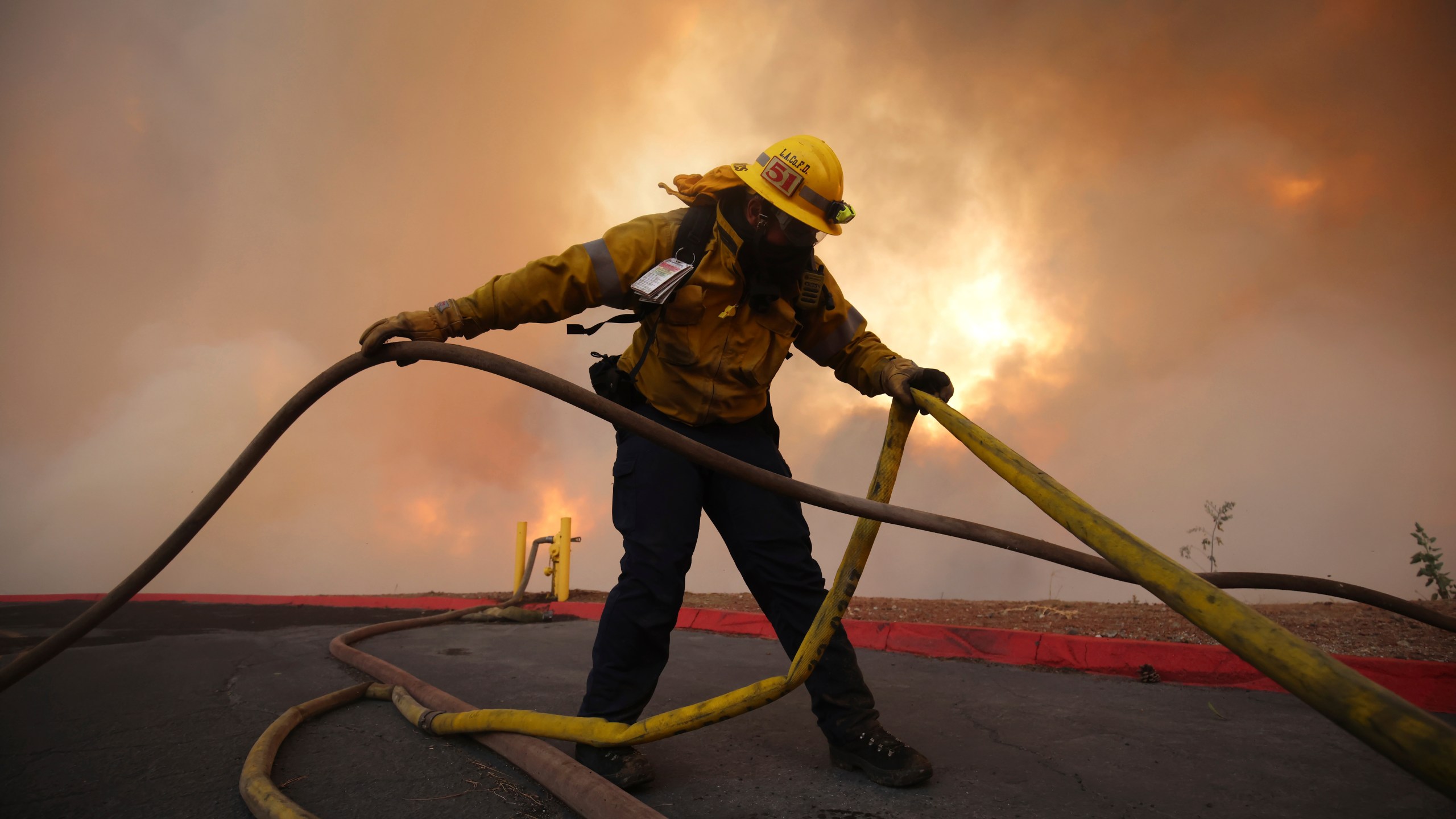 A firefighter fights the Hughes Fire in Castaic, Calif., Wednesday, Jan. 22, 2025.