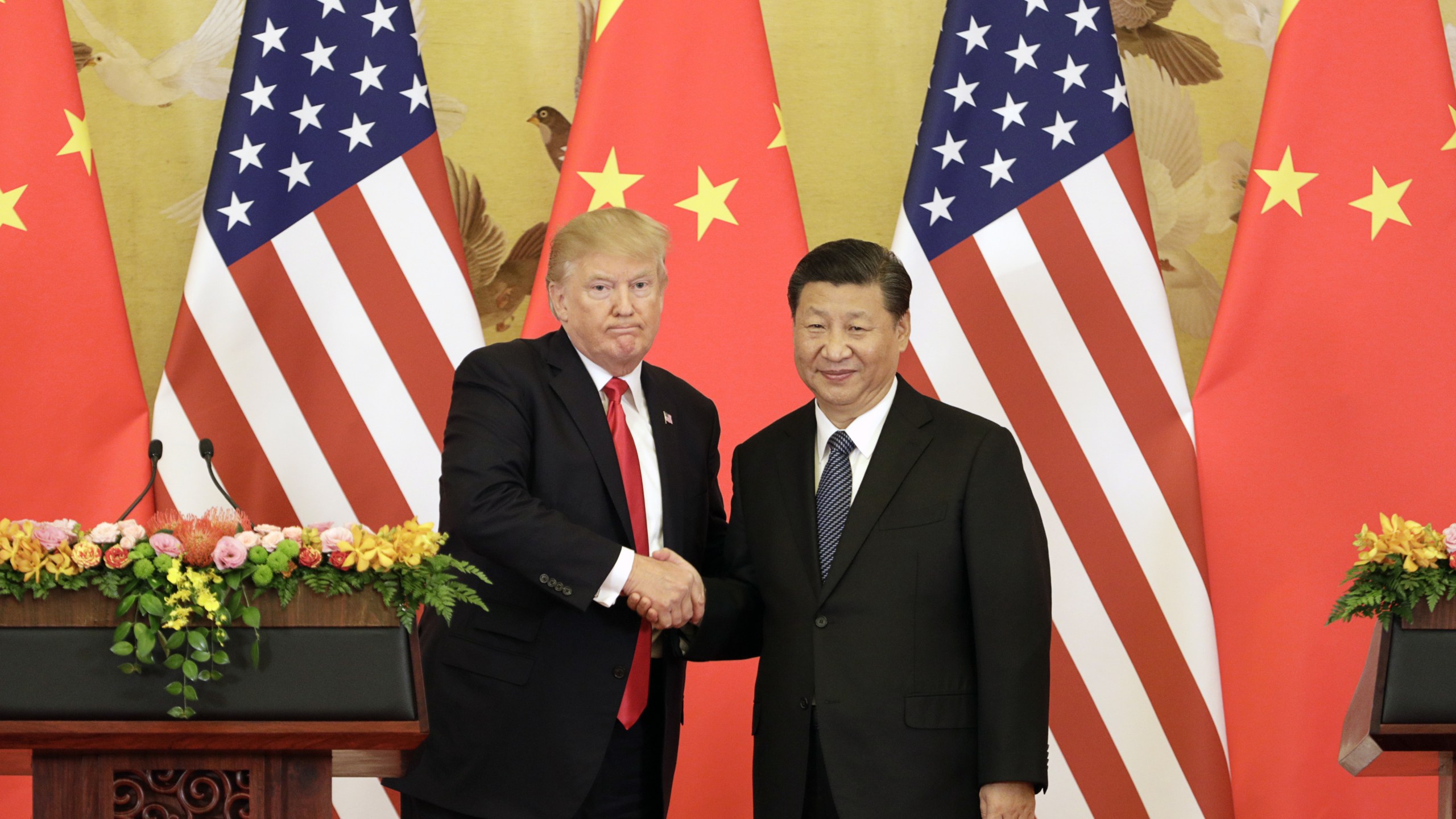 Donald Trump and Xi Jinping shake hands