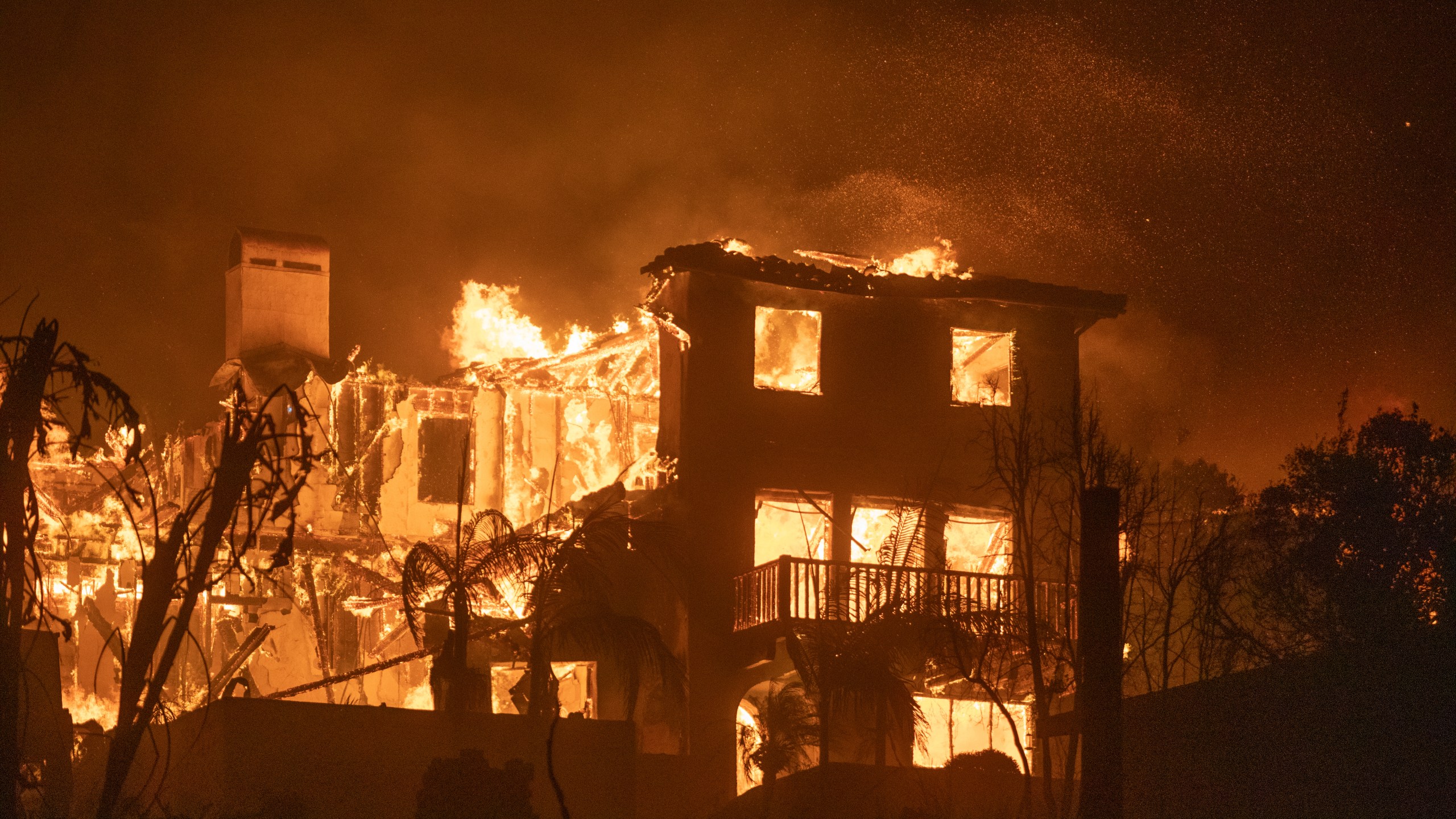 A home on fire during the Palisades Fire