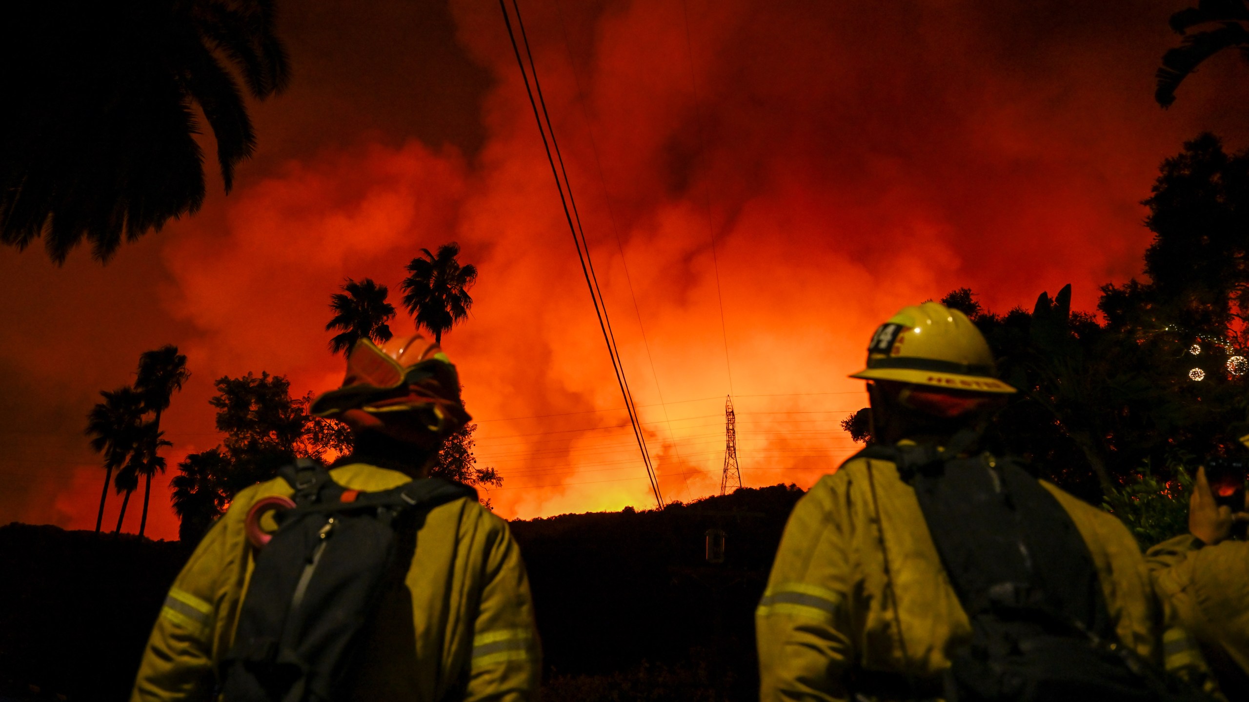 Firefighting planes and helicopters drop water over flames in Mandeville Canyon in Los Angeles.