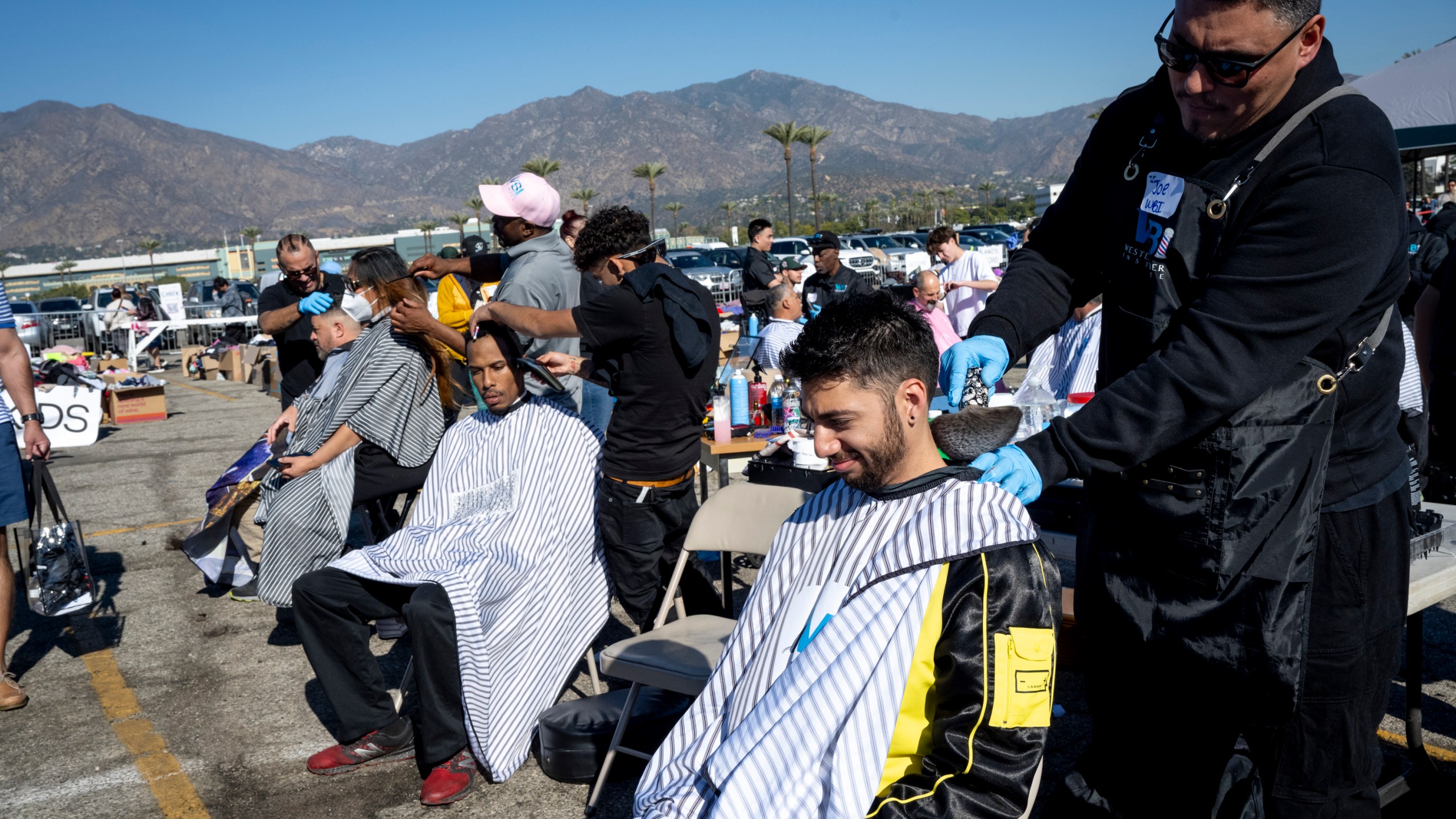Joe Gonzalez, a Western Barber student, gives a haircut to LA fire victims.