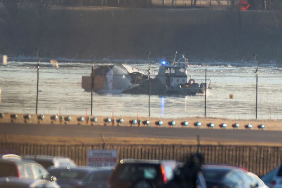 Crews search a river in the aftermath of a plane crash