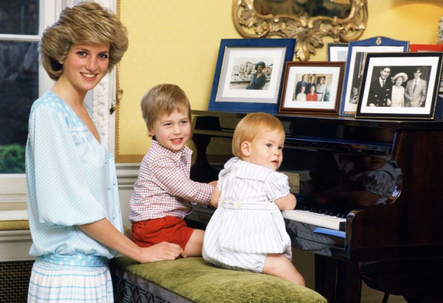 Diana with young Harry and William sitting at a piano
