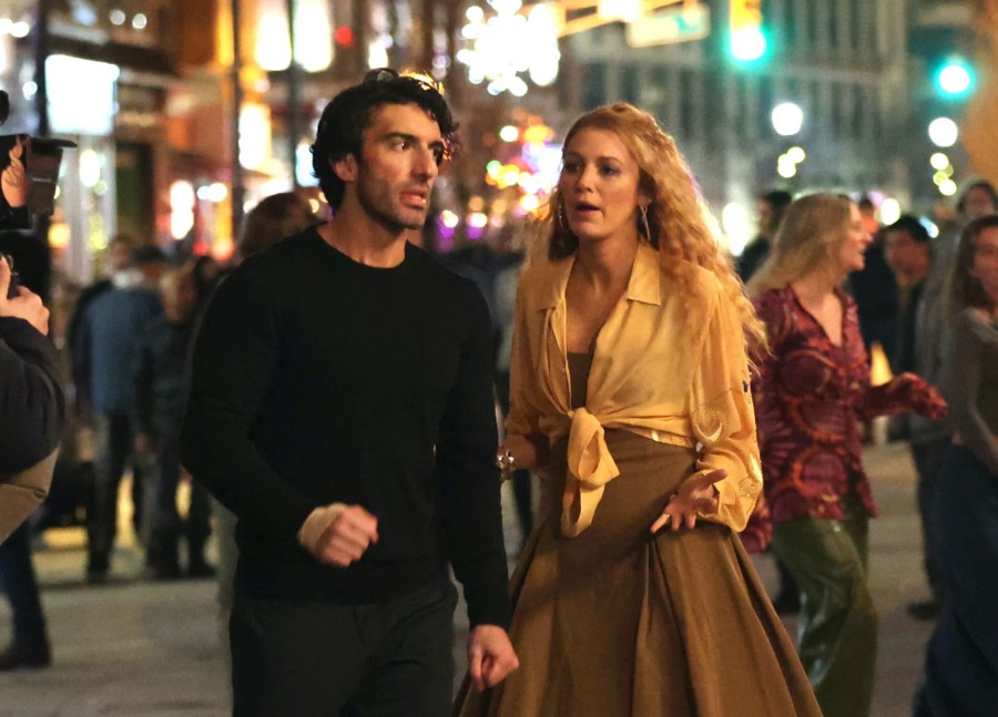 Justin Baldoni and Blake Lively film a scene on a crowded plaza