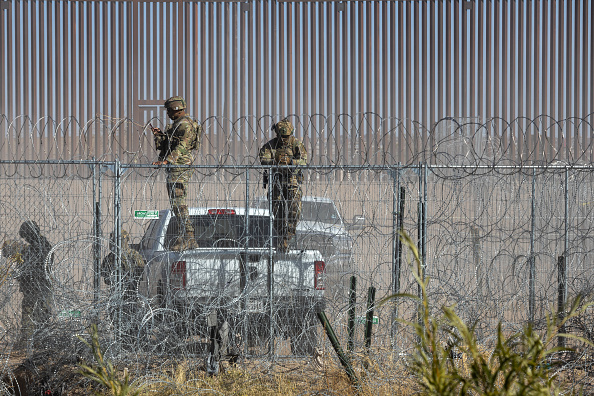 Members of the Texas Army National Guard monitor migrants along the US-Mexico border in Juarez, Chihuahua state, Mexico, on Wednesday, Dec. 18, 2024.