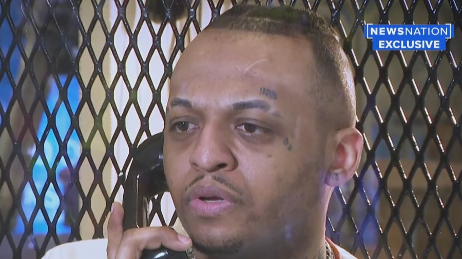 inmates close up with phone to his ear