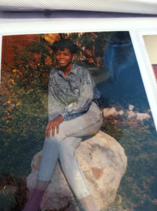 A woman sitting on a rock