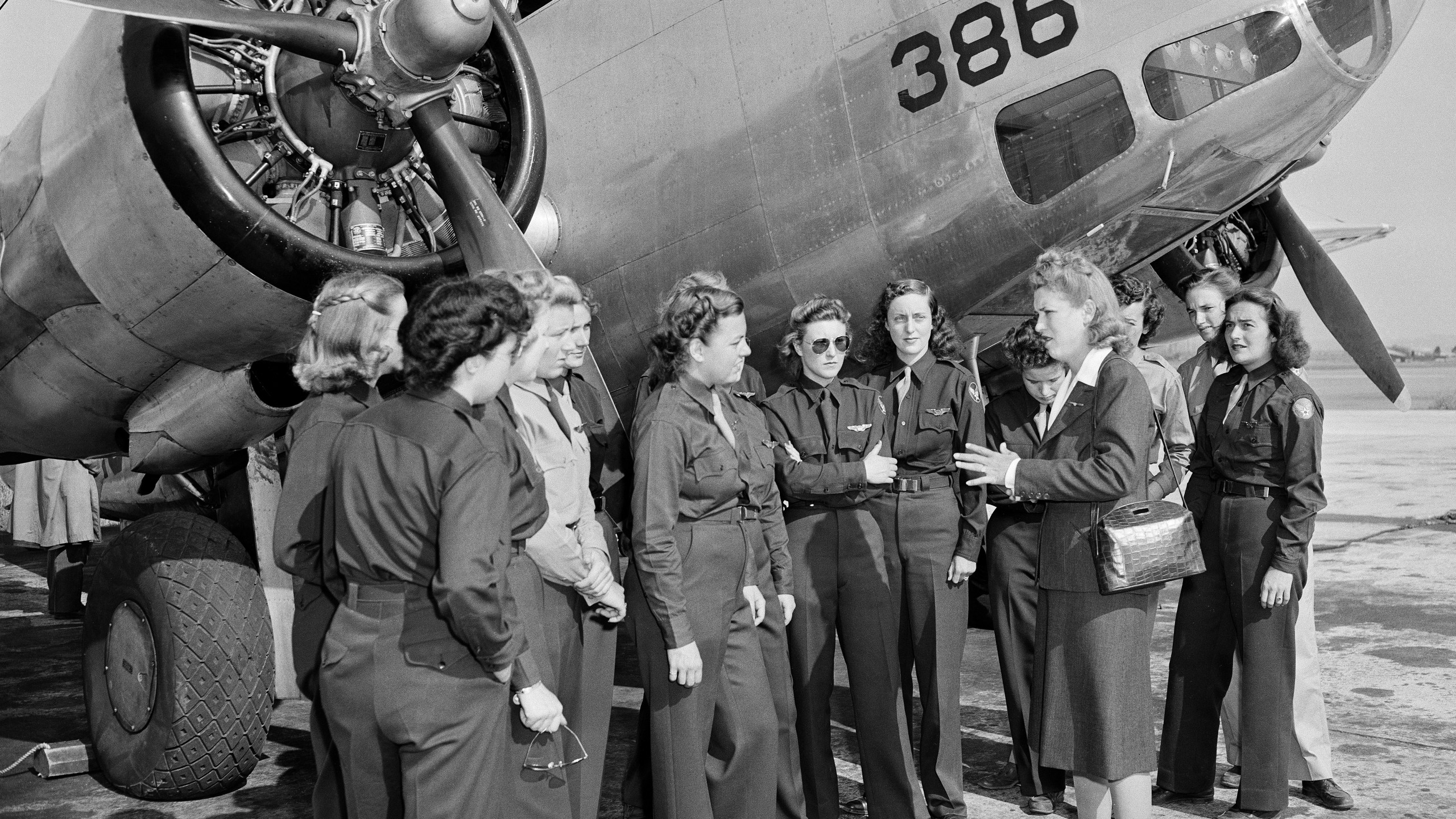 FILE - Jacqueline Cochran, Director of Women Pilots for the Army Air Forces, talks to members of the Women Airforce Service Pilots before an AT10 plane at Camp Davis, N.C., Oct. 24, 1943. These WASPS serve as an auxiliary unit working with the U.S. air and ground forces. (AP Photo, File)