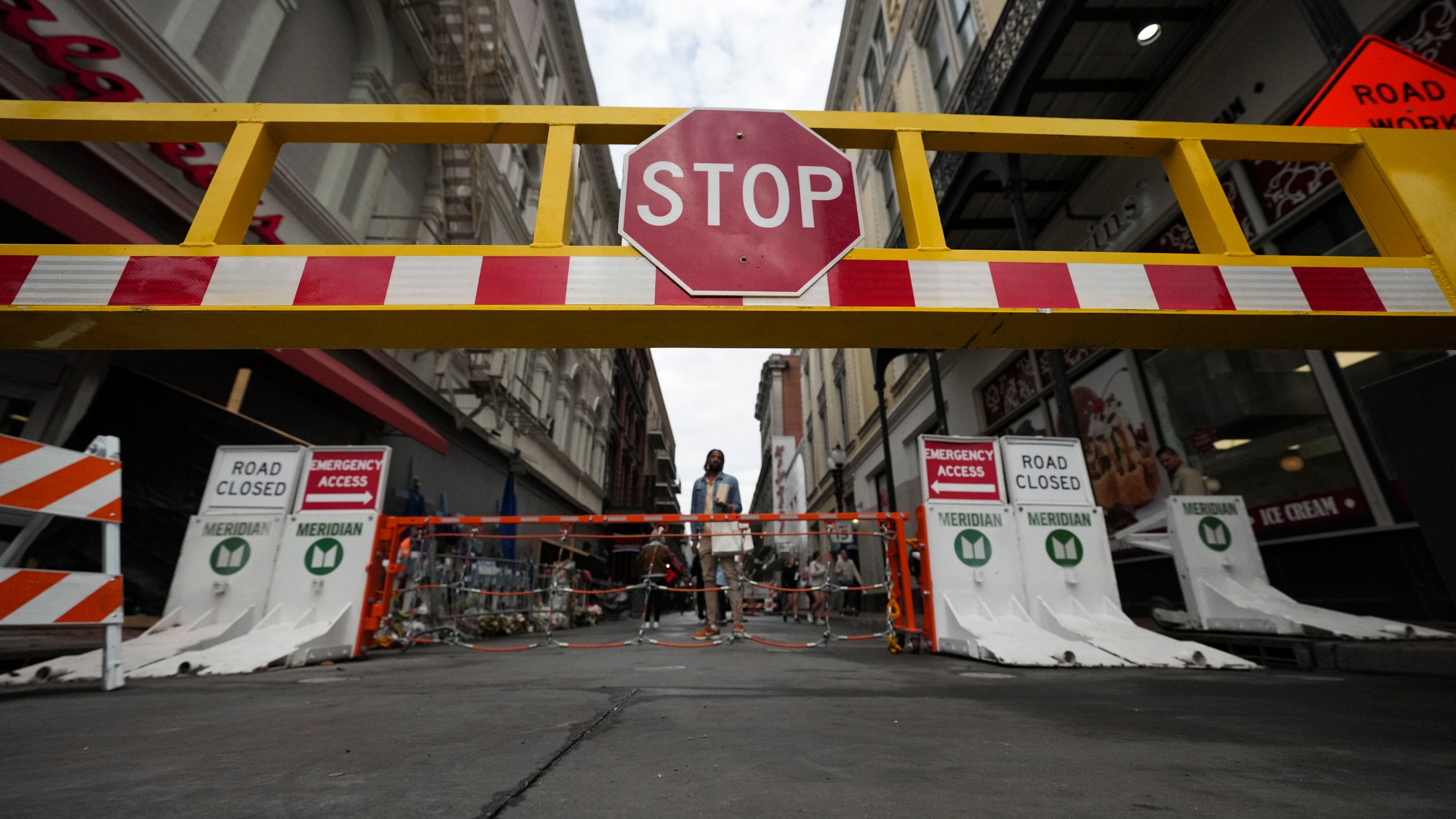 Newly installed security barriers are seen on Bourbon Street next to a memorial for victims of the Jan. 1 car attack ahead of the Super Bowl in New Orleans, Friday, Jan. 31, 2025. (AP Photo/Gerald Herbert)