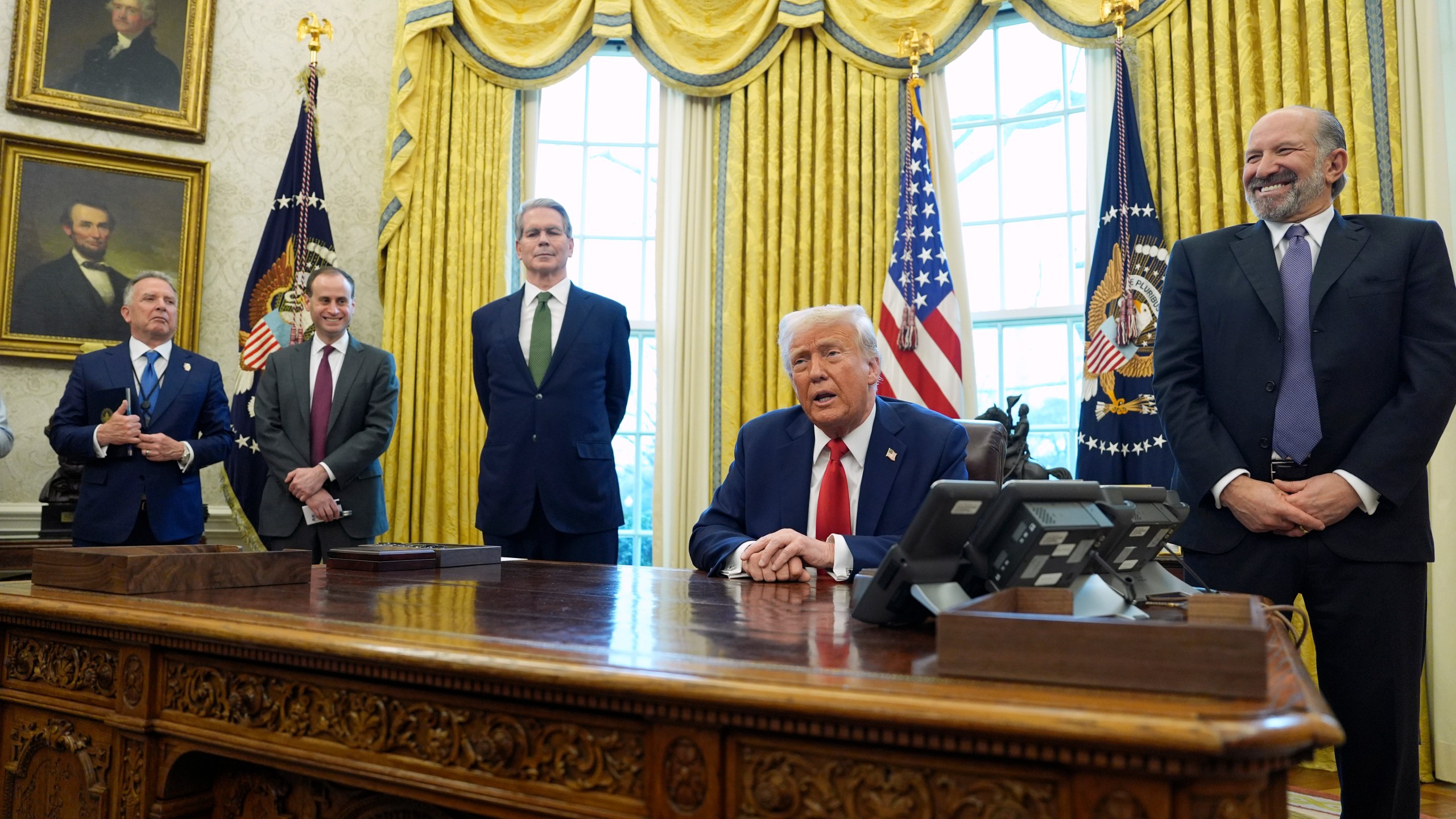 President Donald Trump speaks as Steve Witkoff, special envoy for the Middle East, from left, White House staff secretary Will Scharf, Treasury Secretary Scott Bessent and Commerce Secretary nominee Howard Lutnick listen as Trump signs executive orders in the Oval Office of the White House, Monday, Feb. 3, 2025, in Washington. (AP Photo/Evan Vucci)