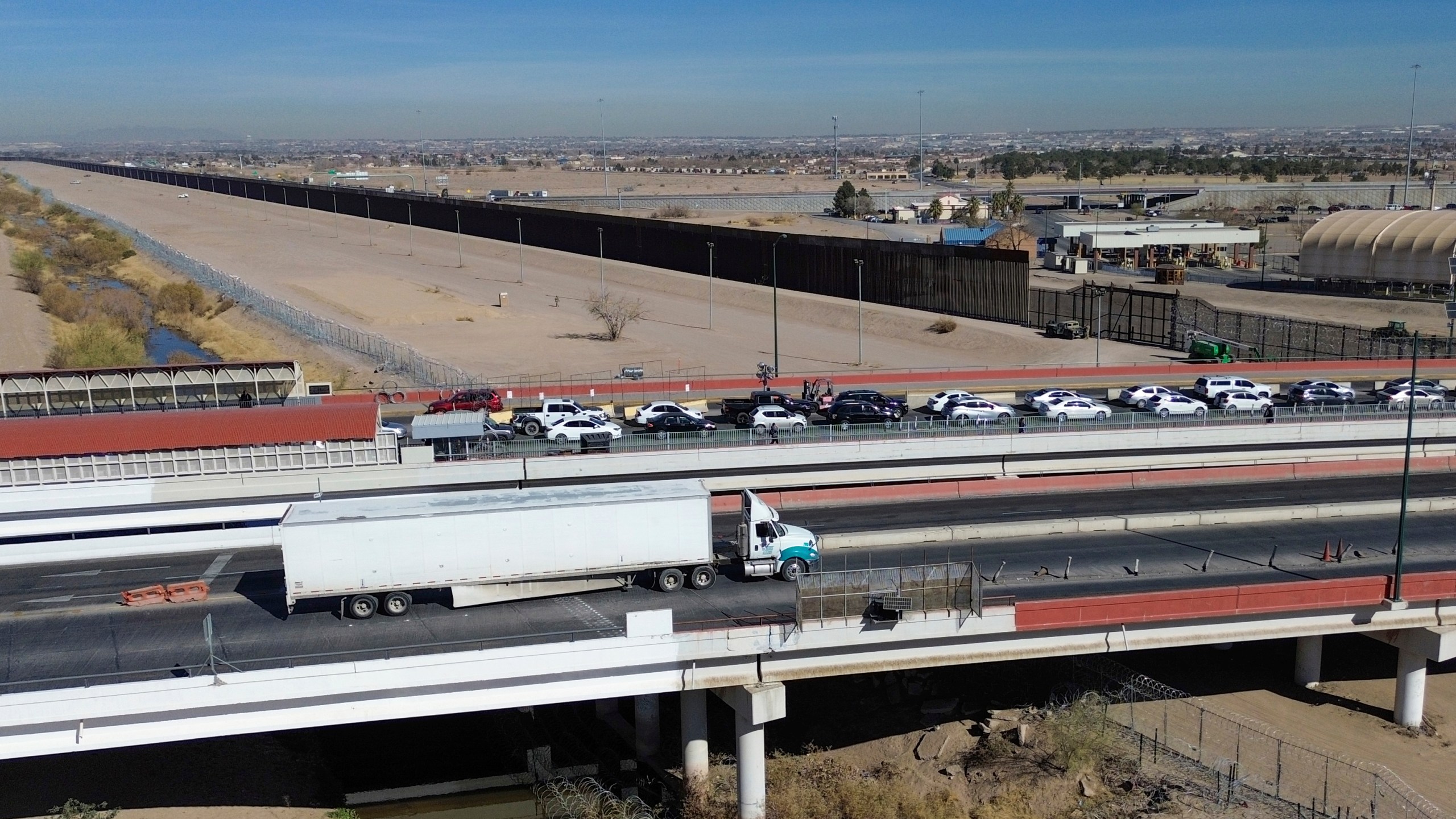 FILE - A truck, bottom, crosses the Zaragoza International Bridge into the U.S., in Ciudad Juarez, Mexico, Monday, Feb. 3, 2025. (AP Photo/Christian Chavez, File)