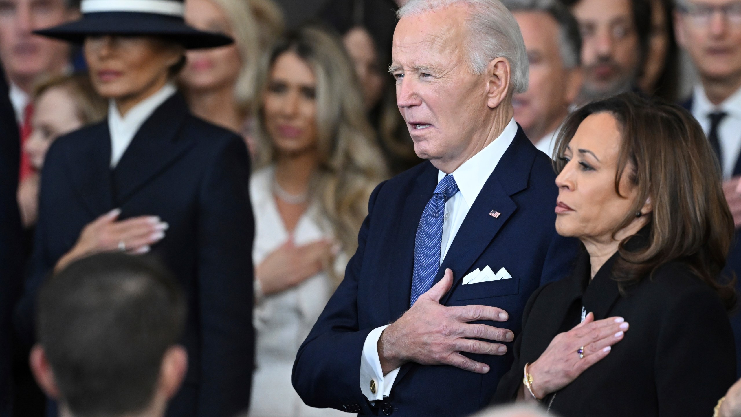Former President Joe Biden and former Vice President Kamala Harris stand as Christopher Macchio performs "The Star-Spangled Banner" after President Donald Trump was sworn in during the 60th Presidential Inauguration in the Rotunda of the U.S. Capitol in Washington, Monday, Jan. 20, 2025. (Saul Loeb/Pool photo via AP)