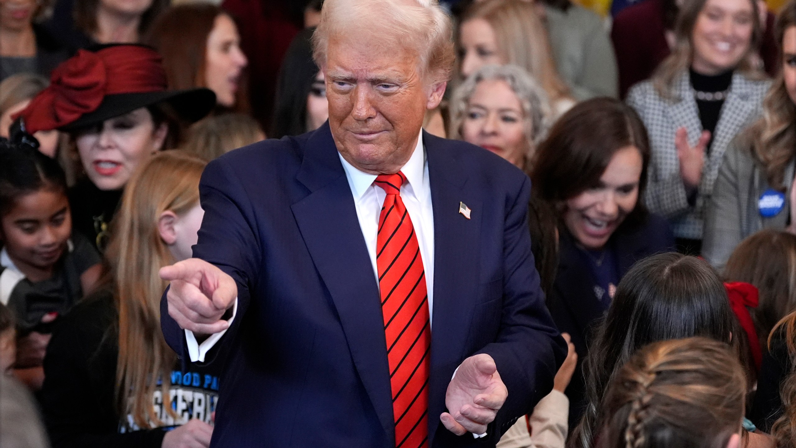 President Donald Trump gestures after signing an executive order.