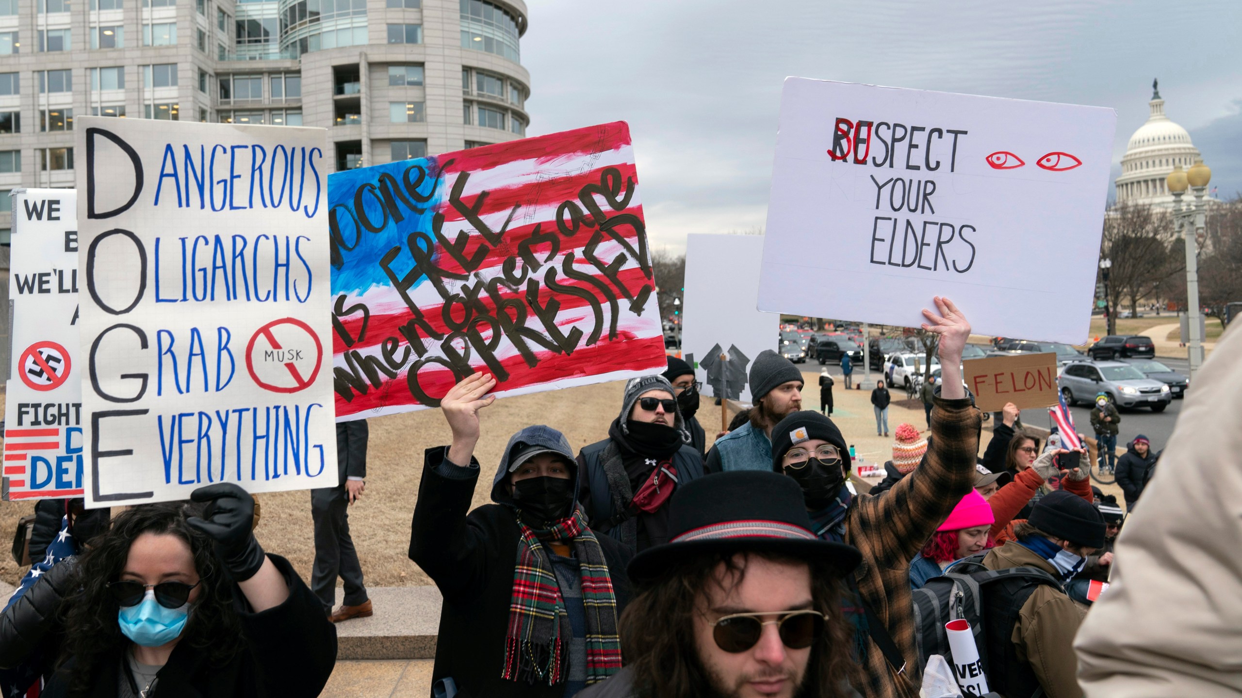 People protest during a rally against Elon Musk outside the U.S. Department of Labor in Washington, Wednesday, Feb. 5, 2025. (AP Photo/Jose Luis Magana)