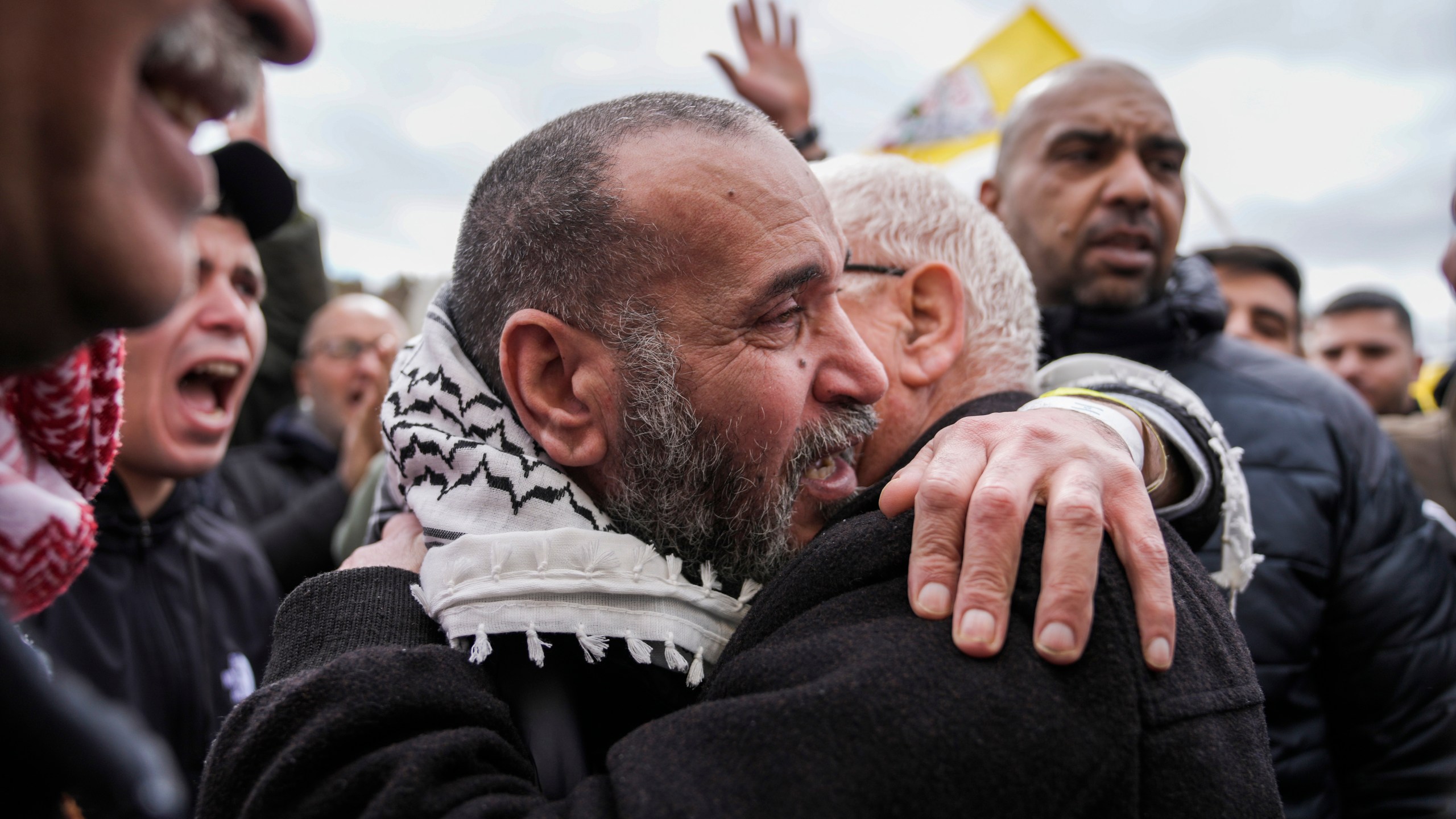 Palestinian prisoners are greeted as they exit a Red Cross bus after being released from Israeli prison following a ceasefire agreement between Israel and Hamas, in the West Bank city of Ramallah, Saturday Feb. 8, 2025. (AP Photo/Mahmoud Illean)