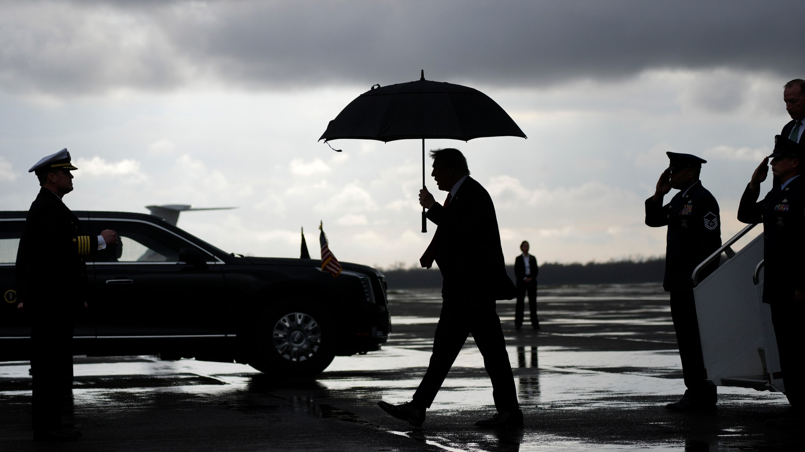 President Donald Trump, center, walks from Air Force Force One after landing at the Naval Air Station Joint Reserve Base in New Orleans, Sunday, Feb. 9, 2025, ahead of the NFL Super Bowl 59 football game between the Philadelphia Eagles and the Kansas City Chiefs. (AP Photo/Ben Curtis)