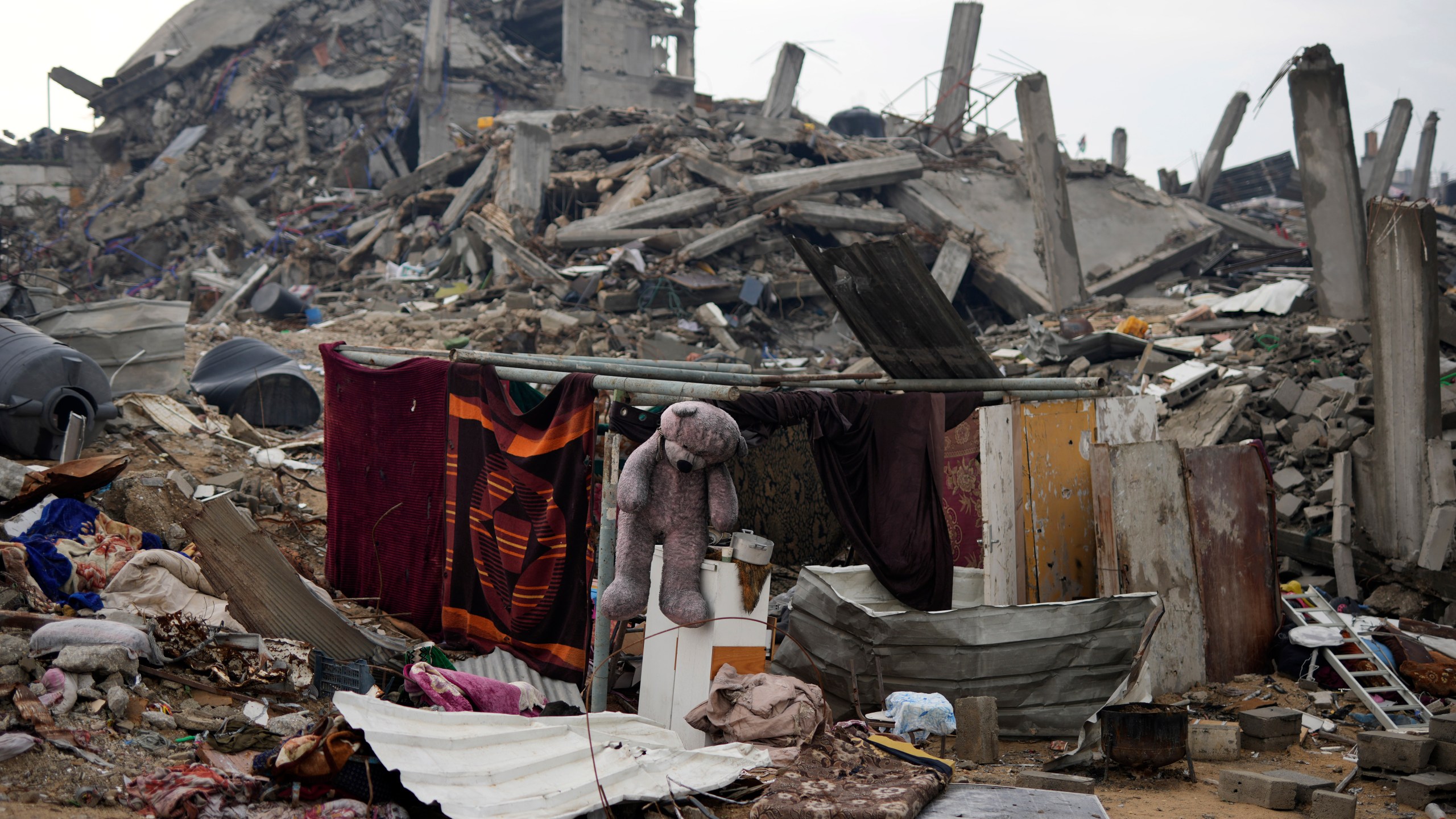 The Rehan family's encampment in the ruins of their home amid widespread destruction caused by the Israeli military's ground and air offensive in Jabaliya, Gaza Strip, Monday, Feb. 10, 2025. (AP Photo/Abdel Kareem Hana)