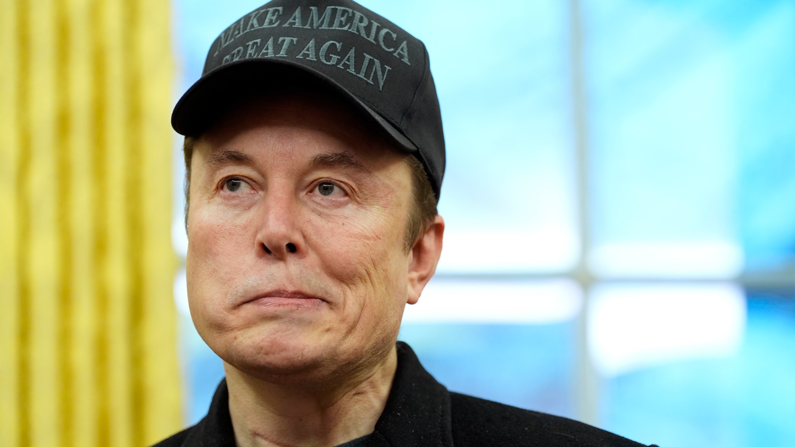 Elon Musk listens during an event in the Oval Office with President Donald Trump at the White House, Tuesday, Feb. 11, 2025, in Washington. (Photo/Alex Brandon)