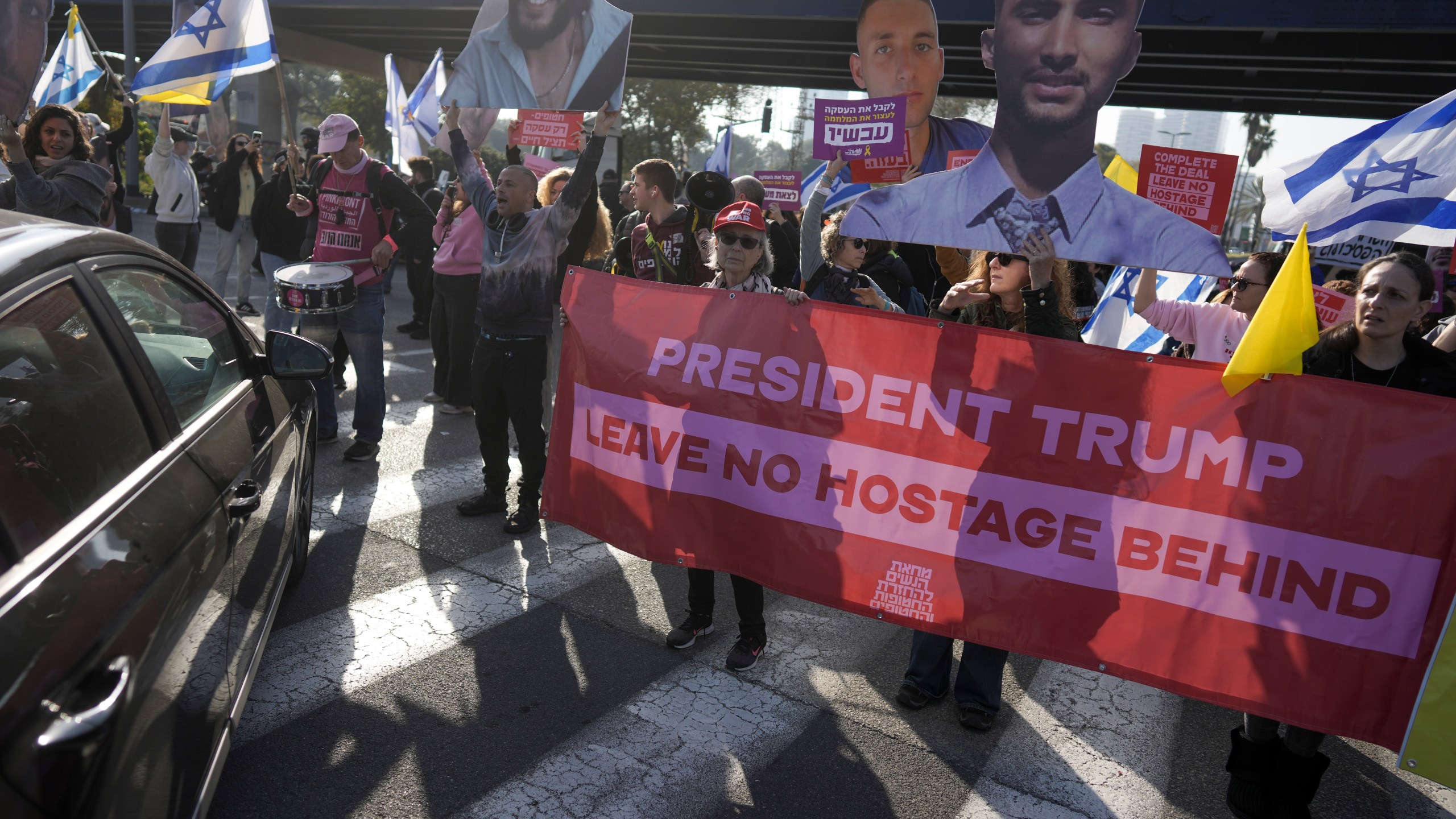 Relatives and supporters of Israelis held hostage in the Gaza Strip, block a freeway during a protest demanding their release from Hamas captivity as they mark 500 days of the Israel-Hamas war in Tel Aviv, Israel, Monday, Feb. 17, 2025. (AP Photo/Oded Balilty)