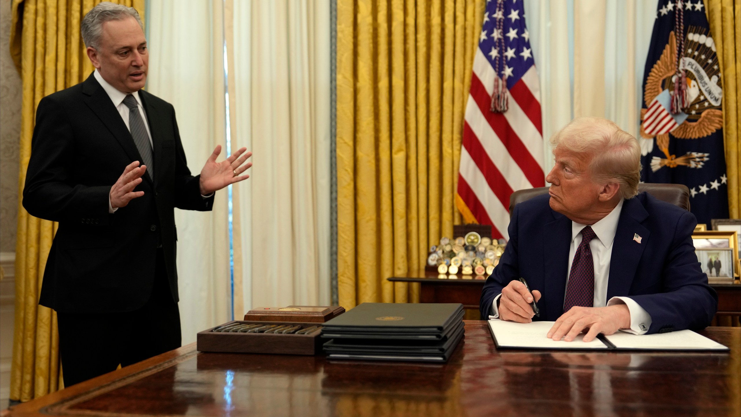 FILE - President Donald Trump listens to White House adviser David Sacks as he signs an executive order regarding cryptocurrency in the Oval Office of the White House, Thursday, Jan. 23, 2025, in Washington. (AP Photo/Ben Curtis, File)