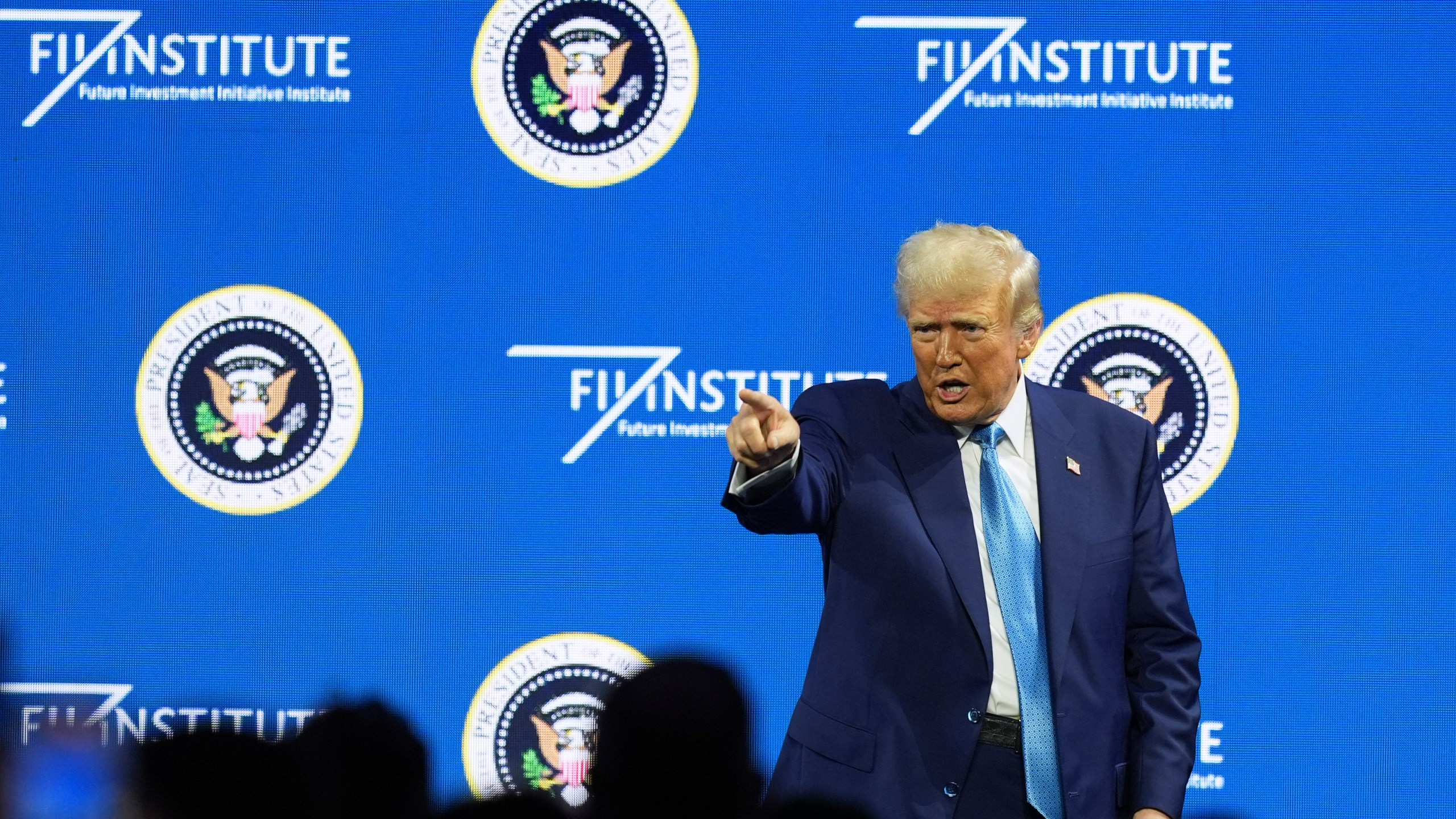 President Donald Trump gestures at the Future Investment Initiative (FII) Institute summit in Miami Beach, Fla., Wednesday, Feb. 19, 2025. (AP Photo/Rebecca Blackwell)