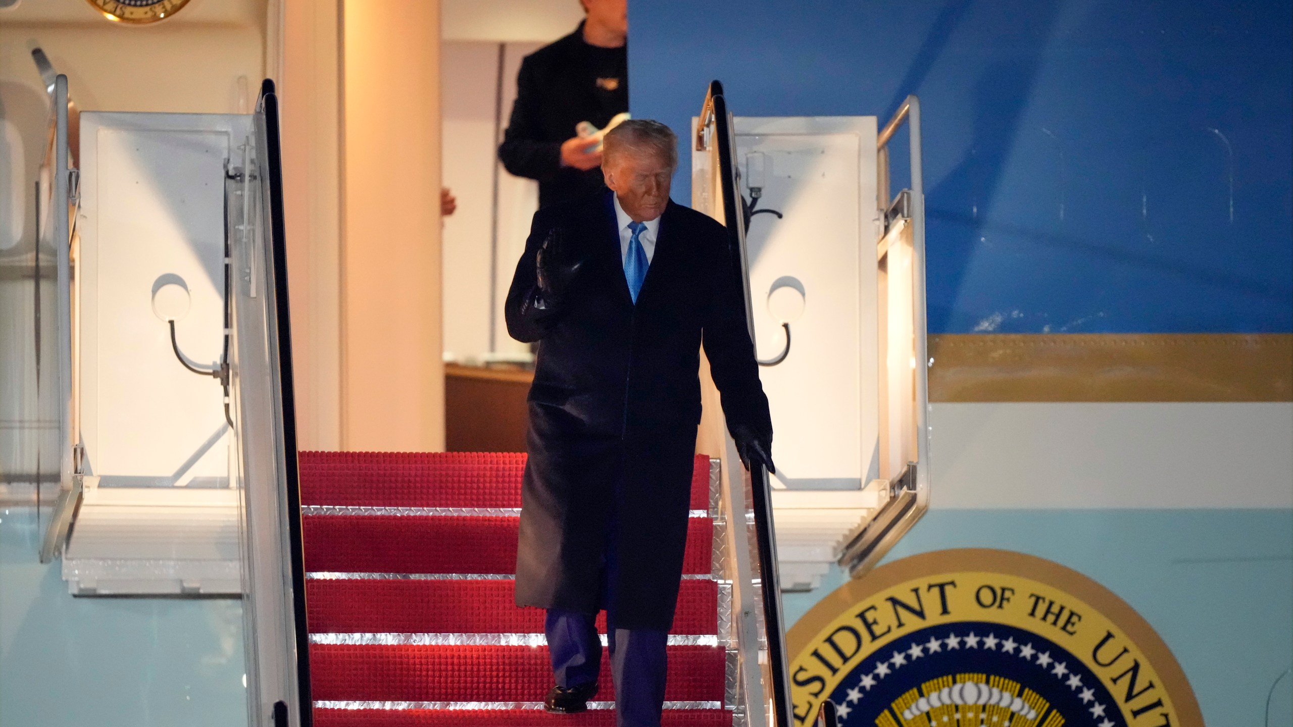 President Donald Trump, followed by Elon Musk, arrives on Air Force One, Wednesday, Feb. 19, 2025, at Joint Base Andrews, Md, after returning from Florida. (AP Photo/Mark Schiefelbein)