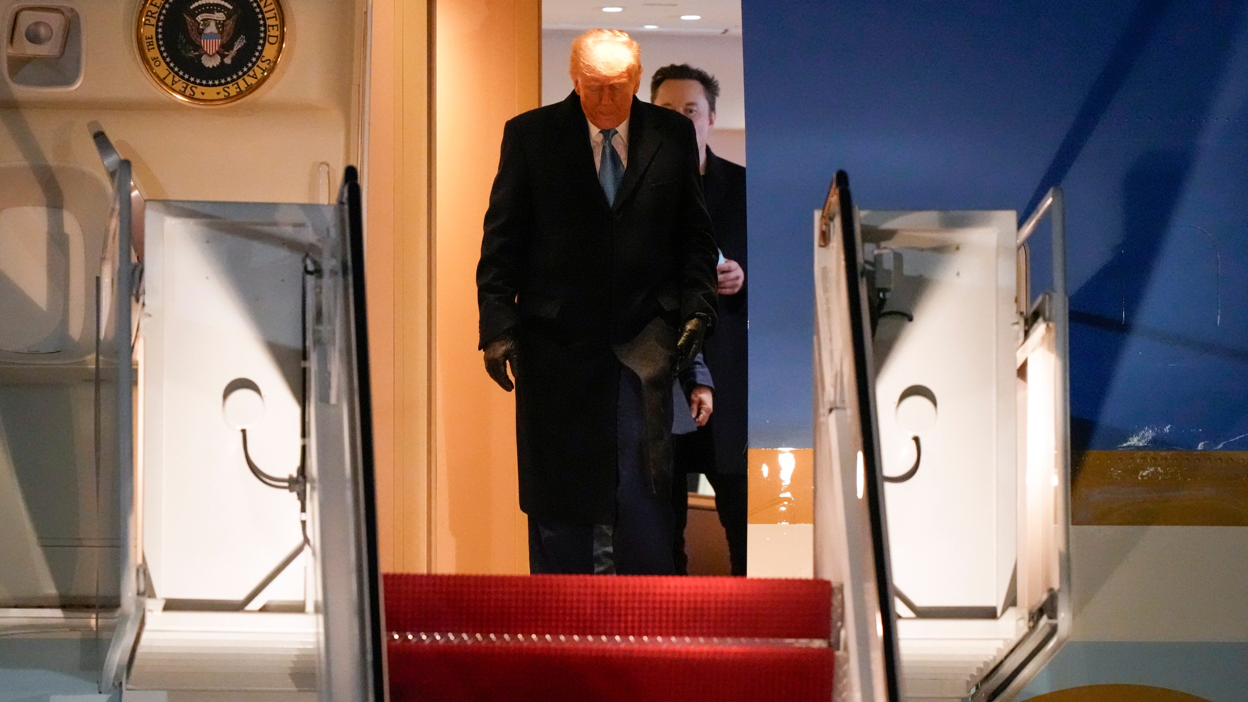 Donald Trump and Elon Musk exit an airplane