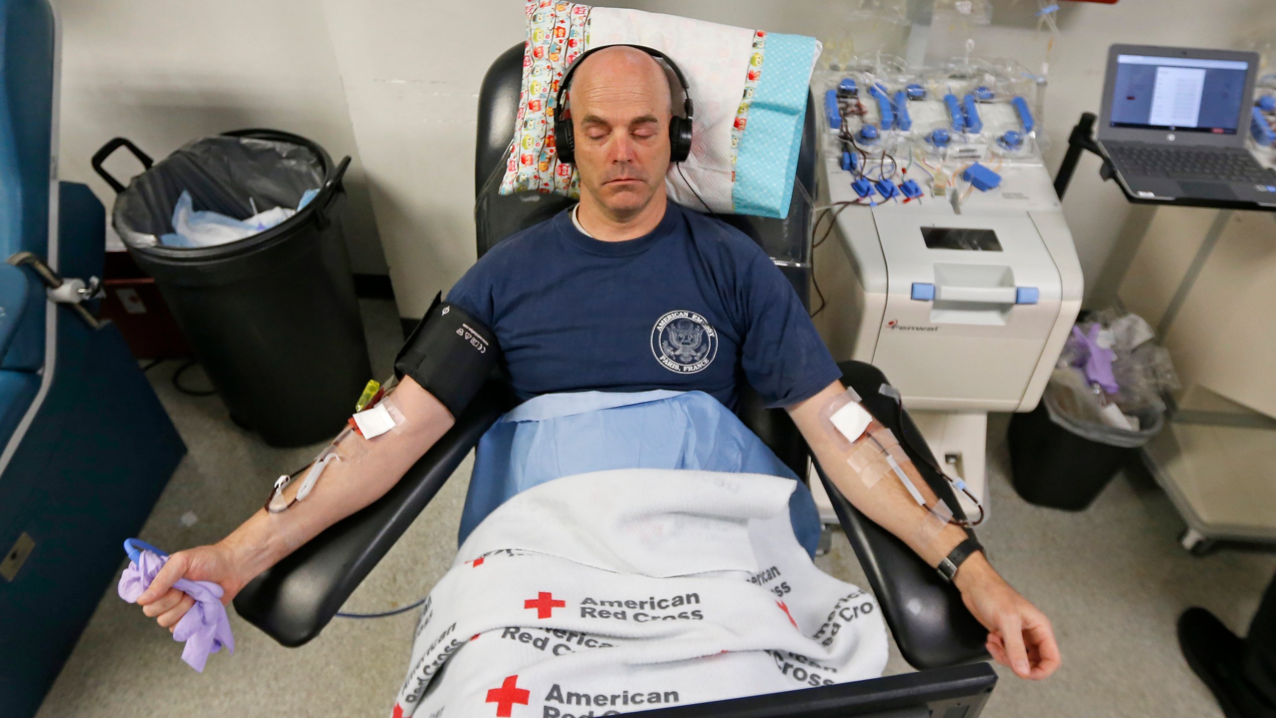 File - Eric Timpson gives blood at the American Red Cross Donation Center, March 23, 2020, in Murray, Utah. (AP Photo/Rick Bowmer, File)