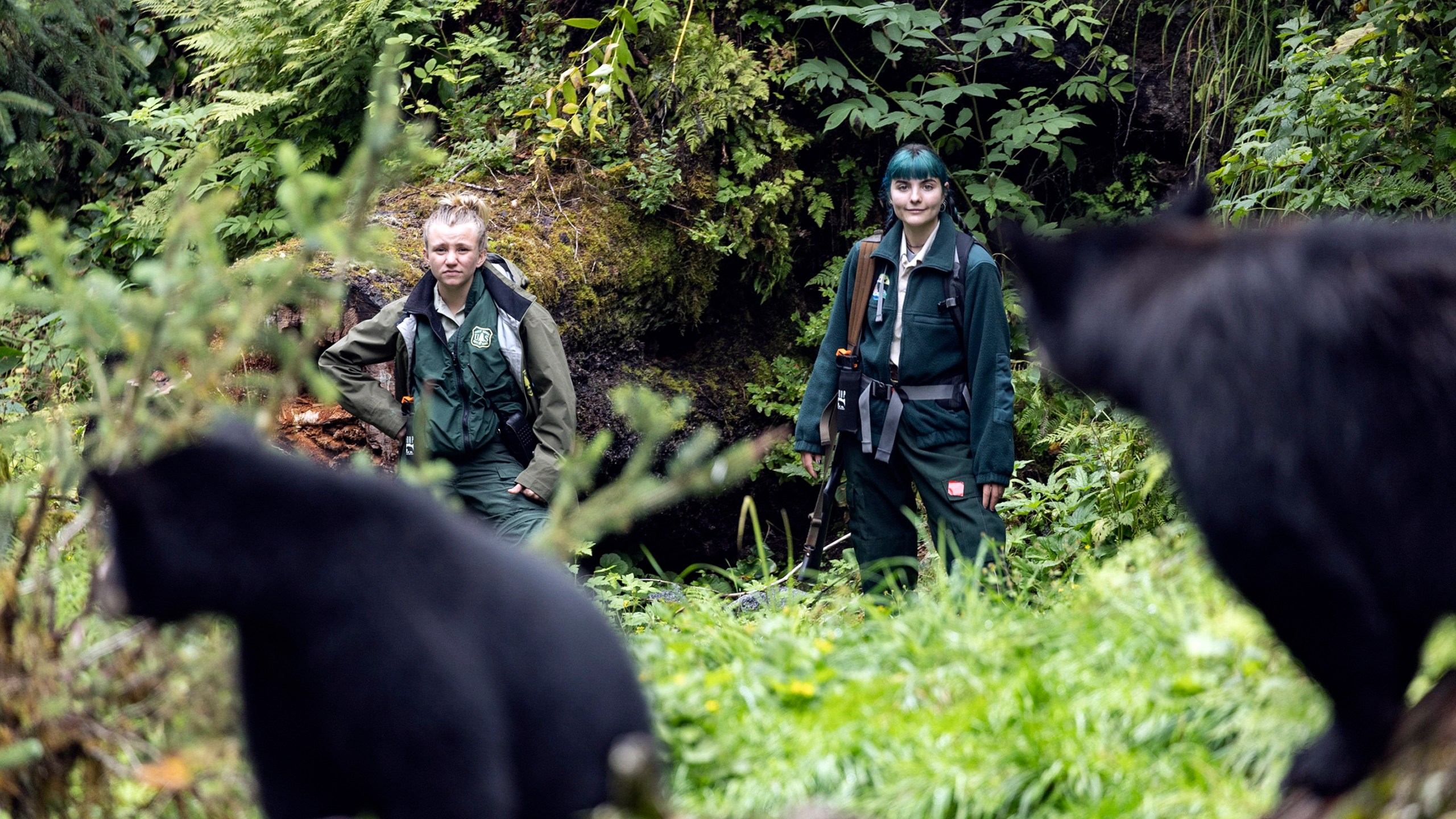 This photo provided by Nathaniel Wilder shows Kayleigh McCarthy, left, keeping an eye on bears at the Anan Wildlife Observatory near Wrangell, Alaska, Aug. 9, 2021. (Nathaniel Wilder via AP)
