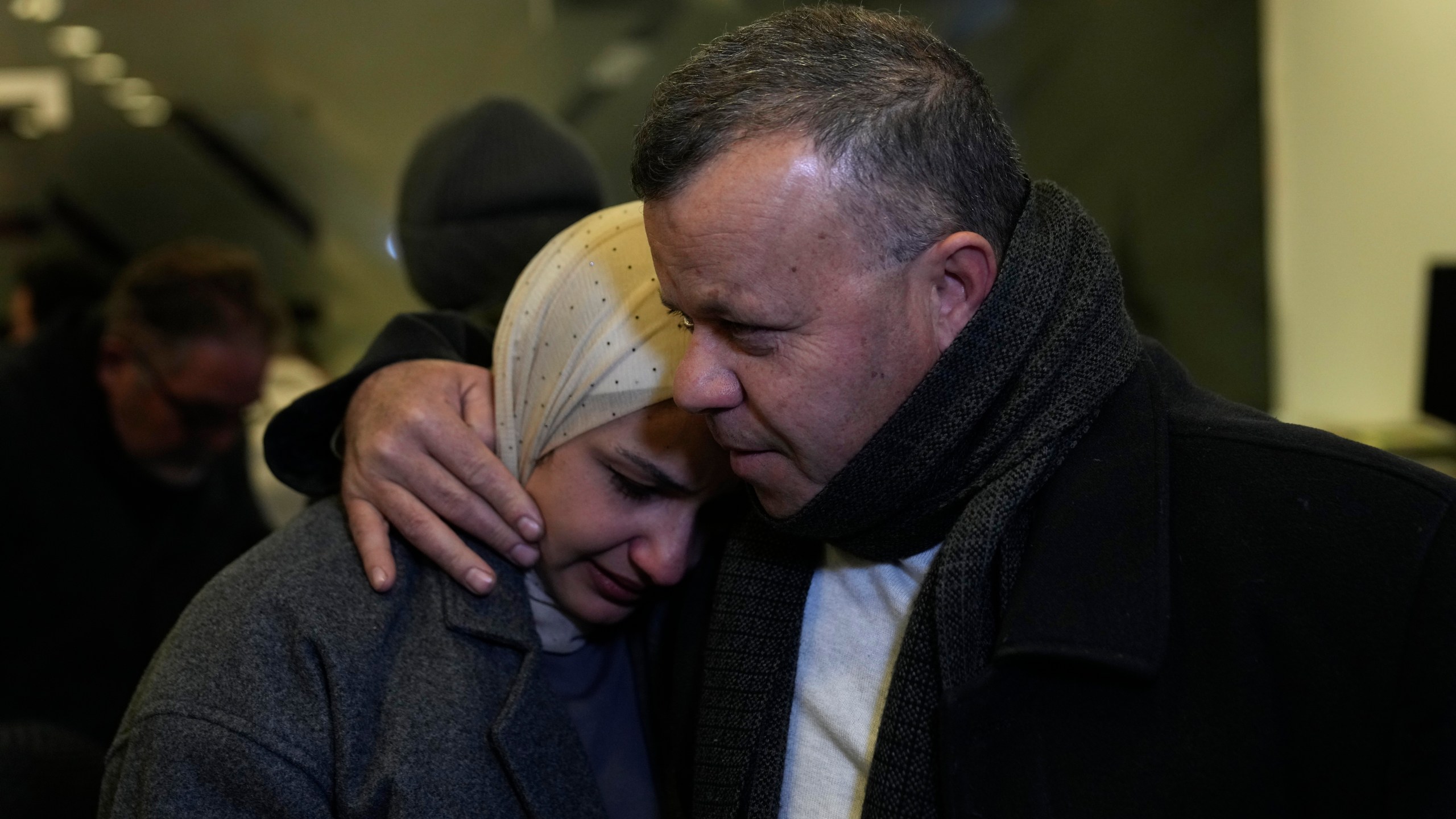 Nadeen, 36, who was waiting for the release of her brother, Ahamd al-Seifi, 35, after he serving 15 years in Israeli jails, is comforted by a relative while crying Sunday, Feb. 23, 2025, after receiving news that Israel has delayed the release of hundreds of Palestinian prisoners scheduled for Saturday, in the West Bank city of Ramallah. (AP Photo/Nasser Nasser)