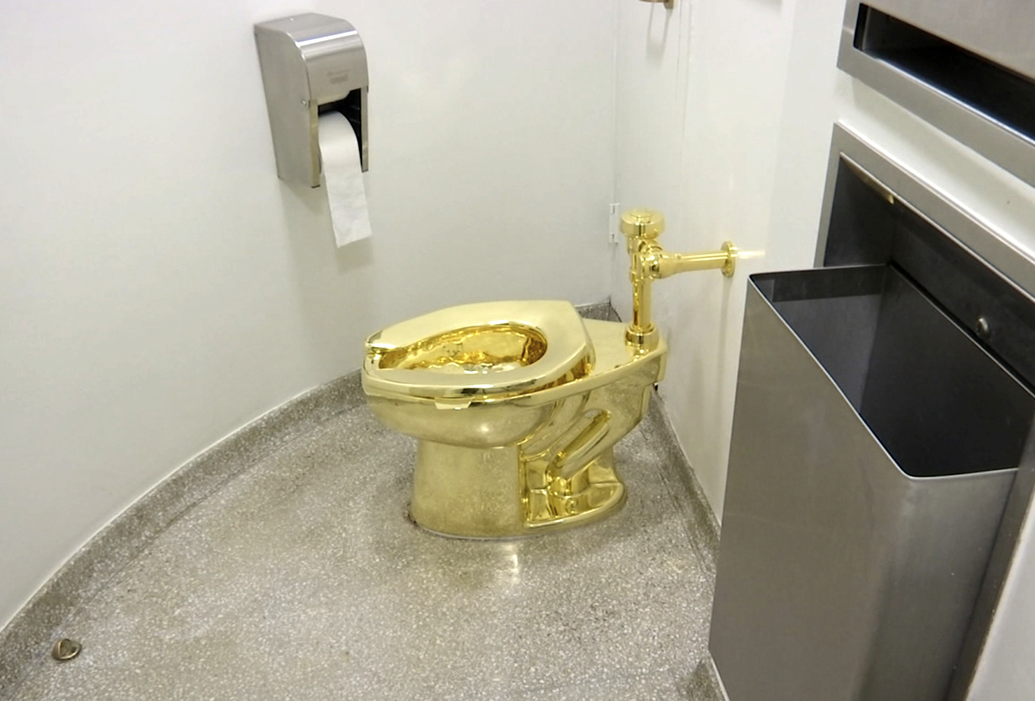 FILE - This screenshot made from a video shows the 18-karat toilet, titled "America," by Maurizio Cattelan in the restroom of the Solomon R. Guggenheim Museum in New York, Sept. 16, 2016. (AP Photo, File)