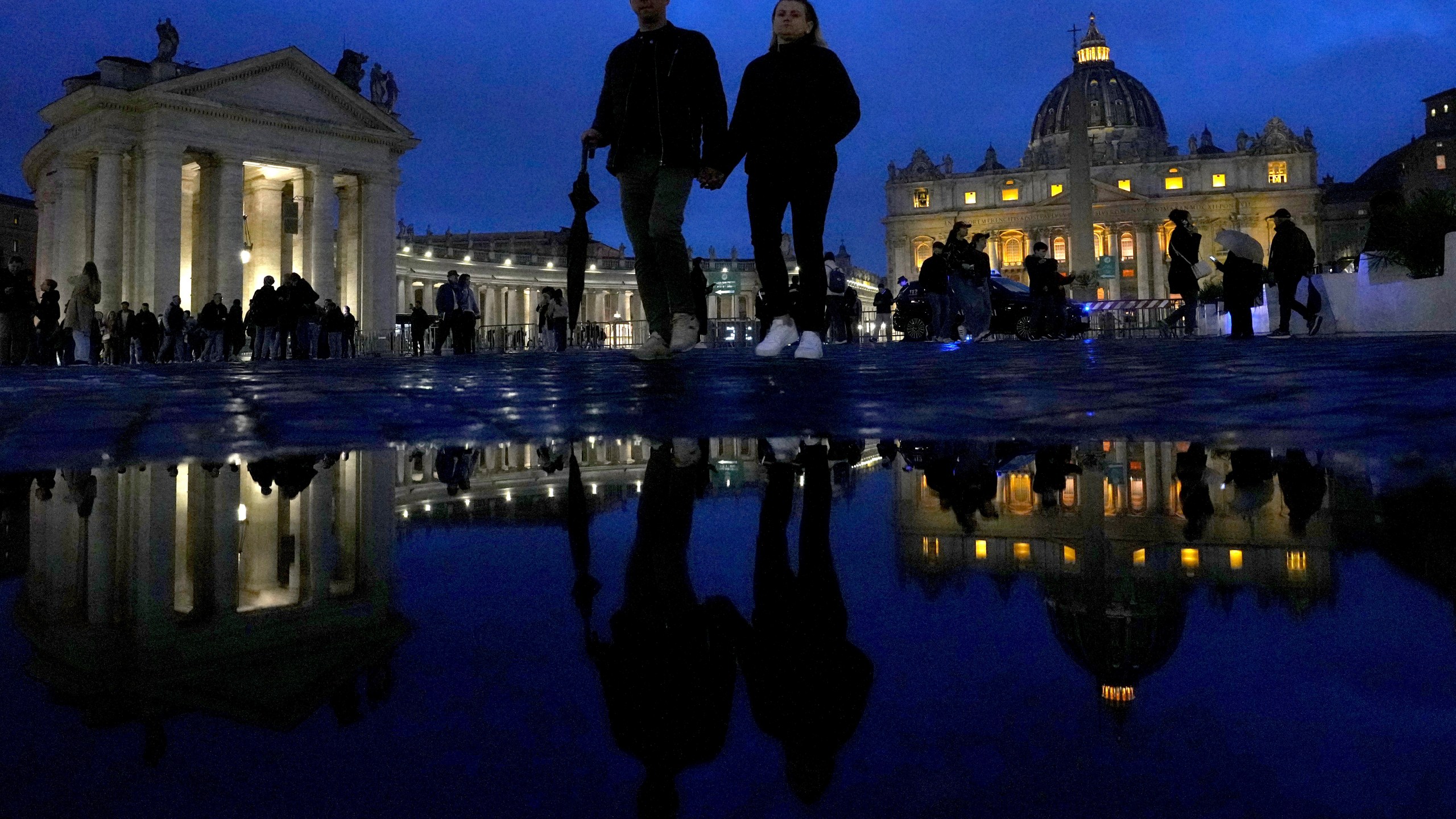 People walk outside St. Peter's Square at The Vatican, Monday, Feb. 24, 2025. (AP Photo/Kirsty Wigglesworth)