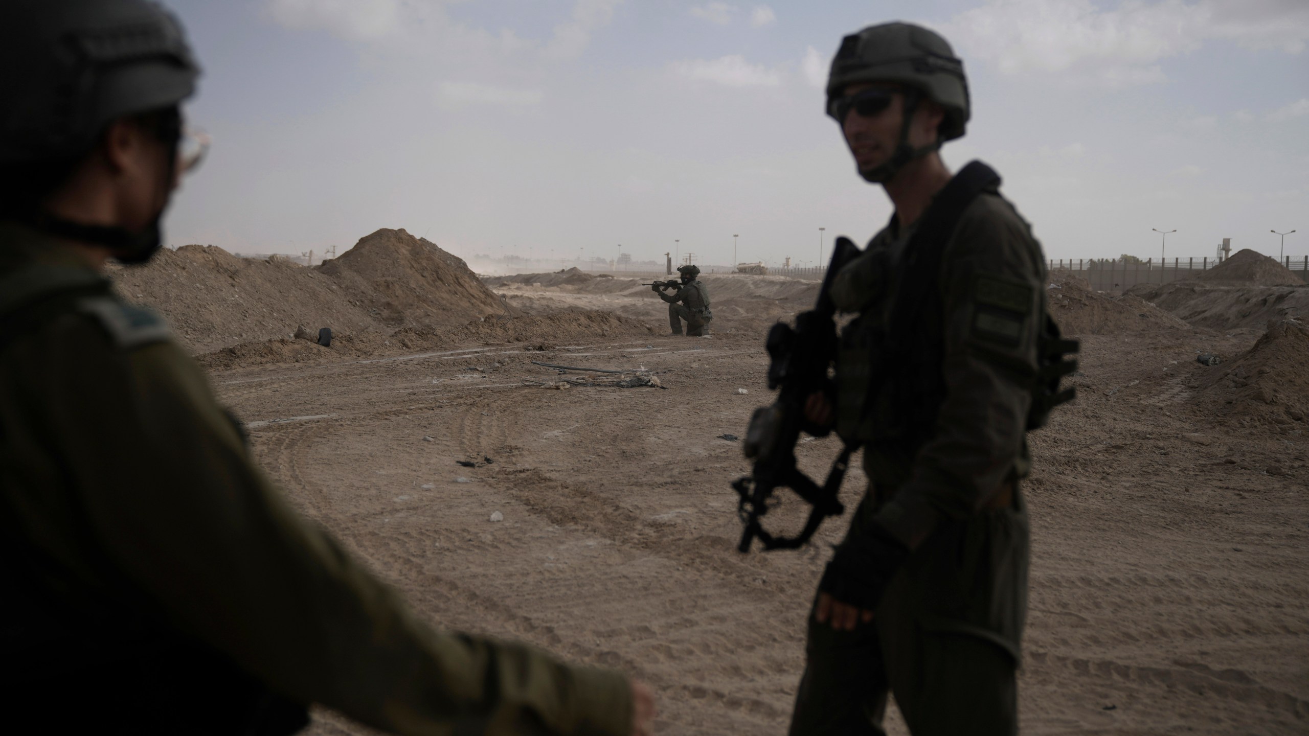 FILE - Israeli soldiers take up positions next to the Philadelphi Corridor along the border with Egypt, in the Gaza Strip, Sept. 13, 2024. (AP Photo/Leo Correa, File)