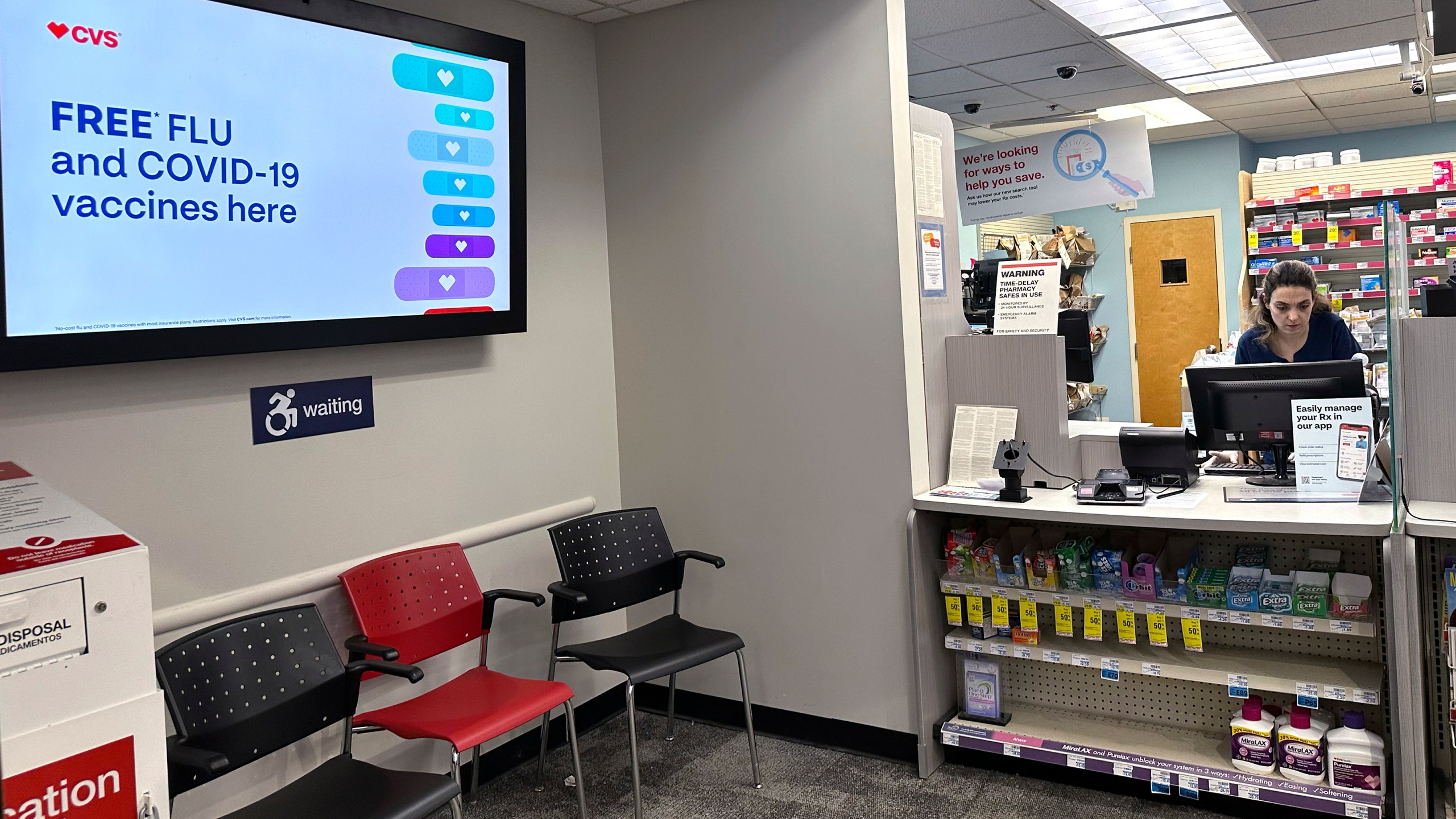 A sign for flu vaccination is displayed on a screen at a pharmacy store in Buffalo Grove, Ill., Tuesday, Feb. 13, 2024. (AP Photo/Nam Y. Huh, File)