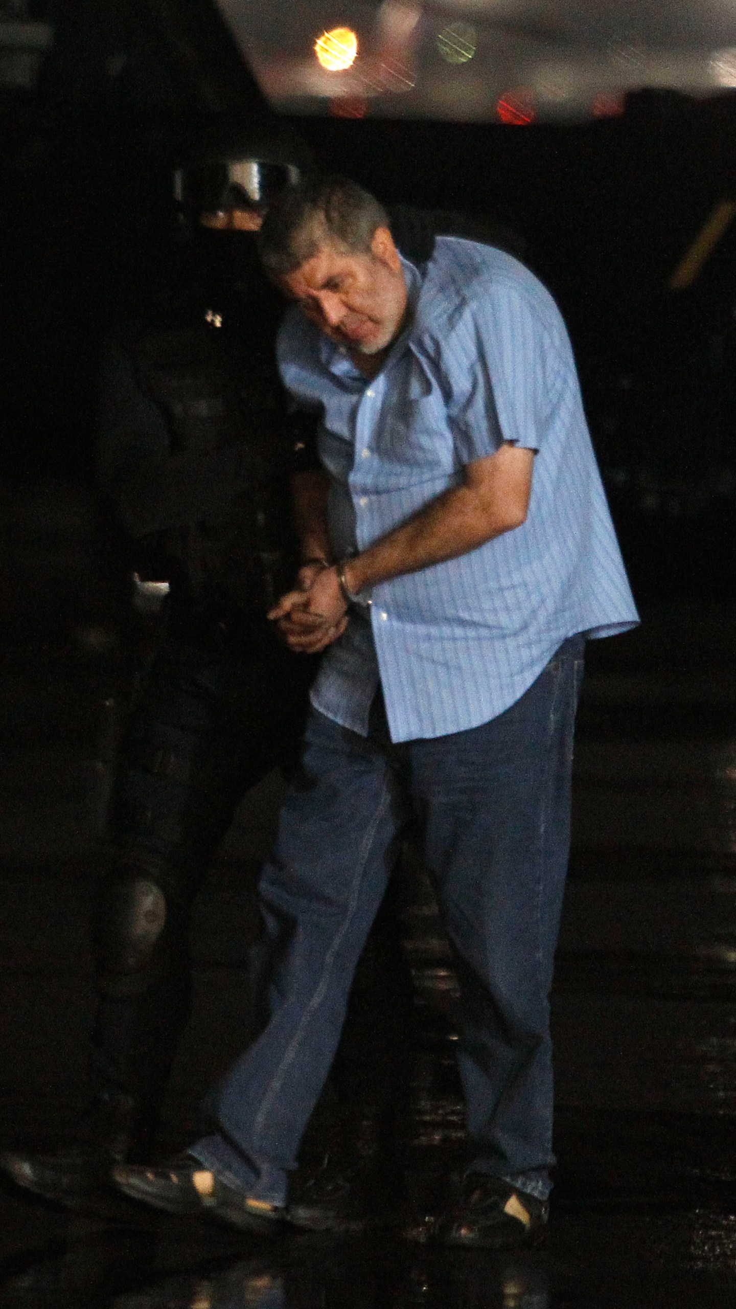FILE - Vicente Carrillo Fuentes, the purported leader of the Juarez cartel, is led to a helicopter after his arrest at the hangar of the Mexican Attorney Generals Office in Mexico City, Oct. 9, 2014. (AP Photo, File)