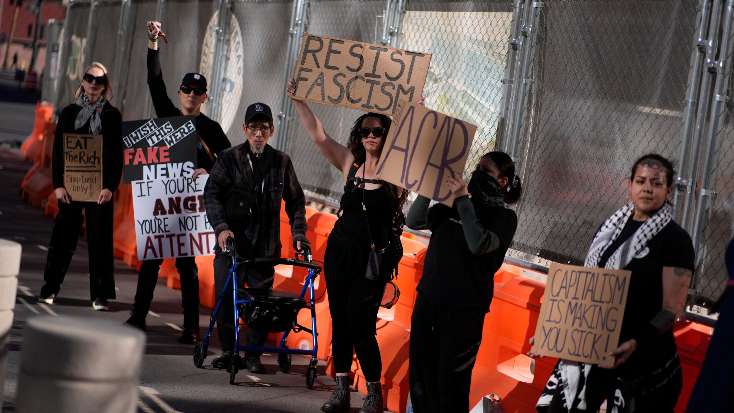 Protestors hold signs during a rally for a nationwide economic blackout Wednesday, Feb. 26, 2025, in Las Vegas. (AP Photo/John Locher)
