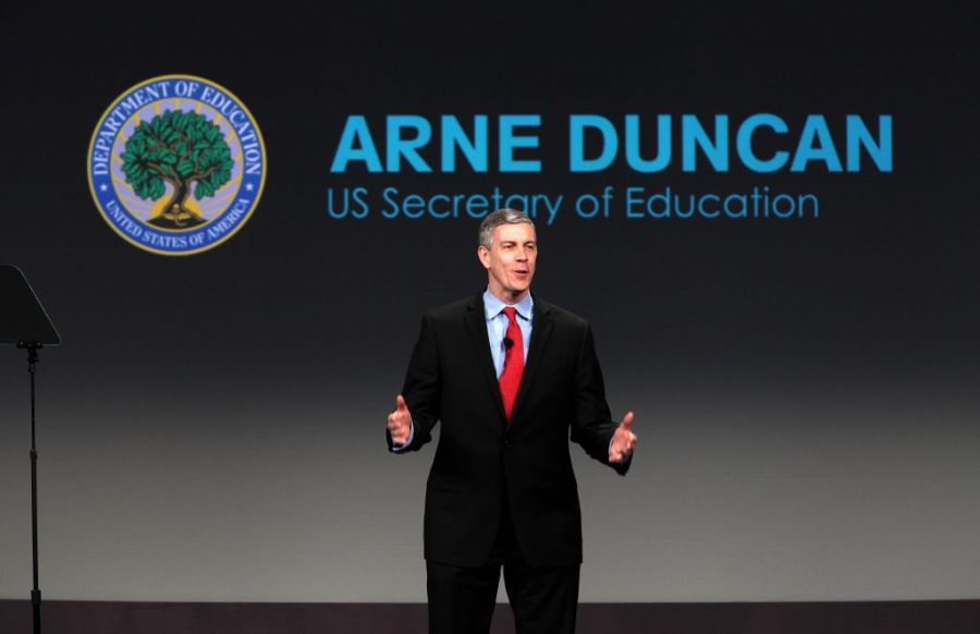 Arne Duncan speaking in front of a crowd.