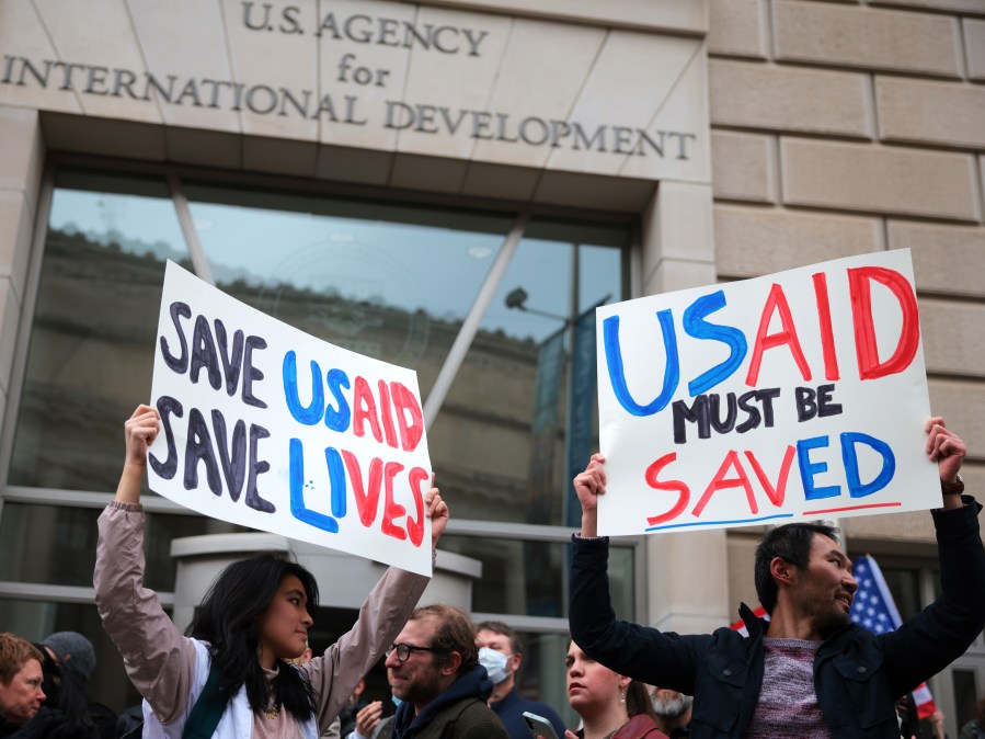 protesters holding signs for USAID