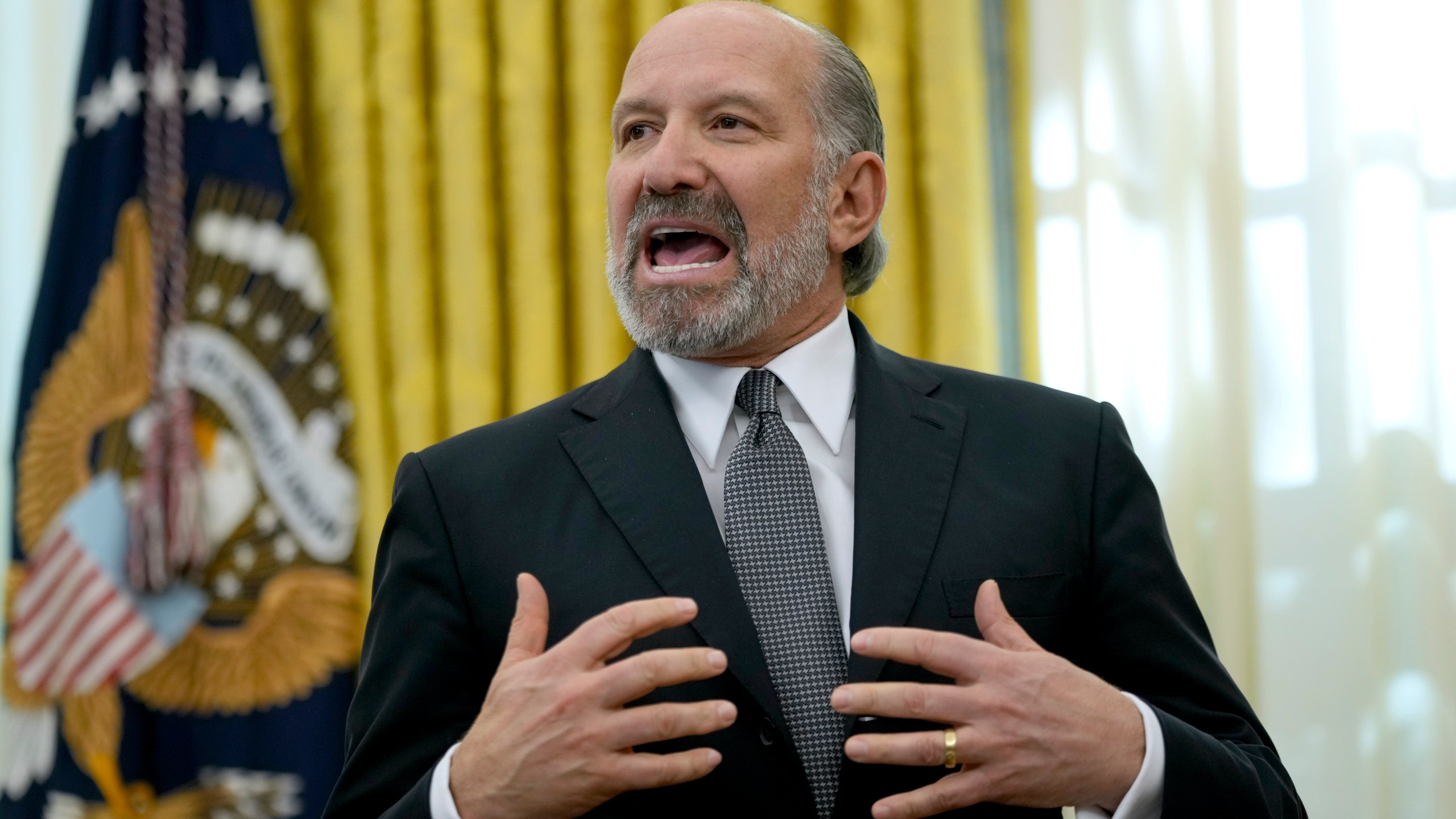 Commerce Secretary nominee Howard Lutnick speaks in the Oval Office of the White House after President Donald Trump signed an executive order, Thursday, Feb. 13, 2025, in Washington. (AP Photo/Ben Curtis)