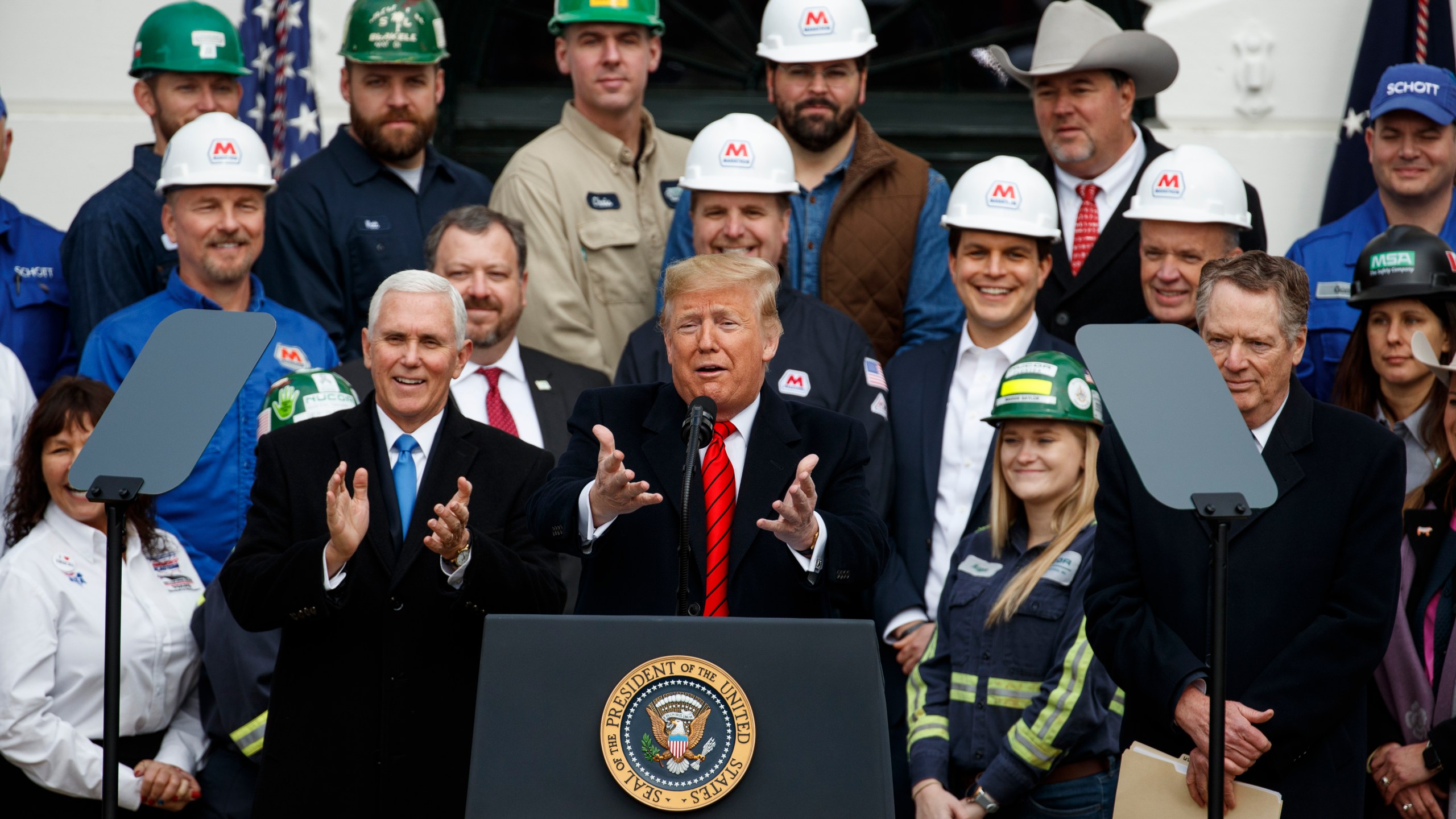 FILE - President Donald Trump speaks during an event at the White House to sign a new North American trade agreement with Canada and Mexico, Jan. 29, 2020, in Washington. The President is joined by Vice President Mike Pence, left, and U.S. Trade Representative Robert Lighthizer, right, and others. (AP Photo/Alex Brandon, File)