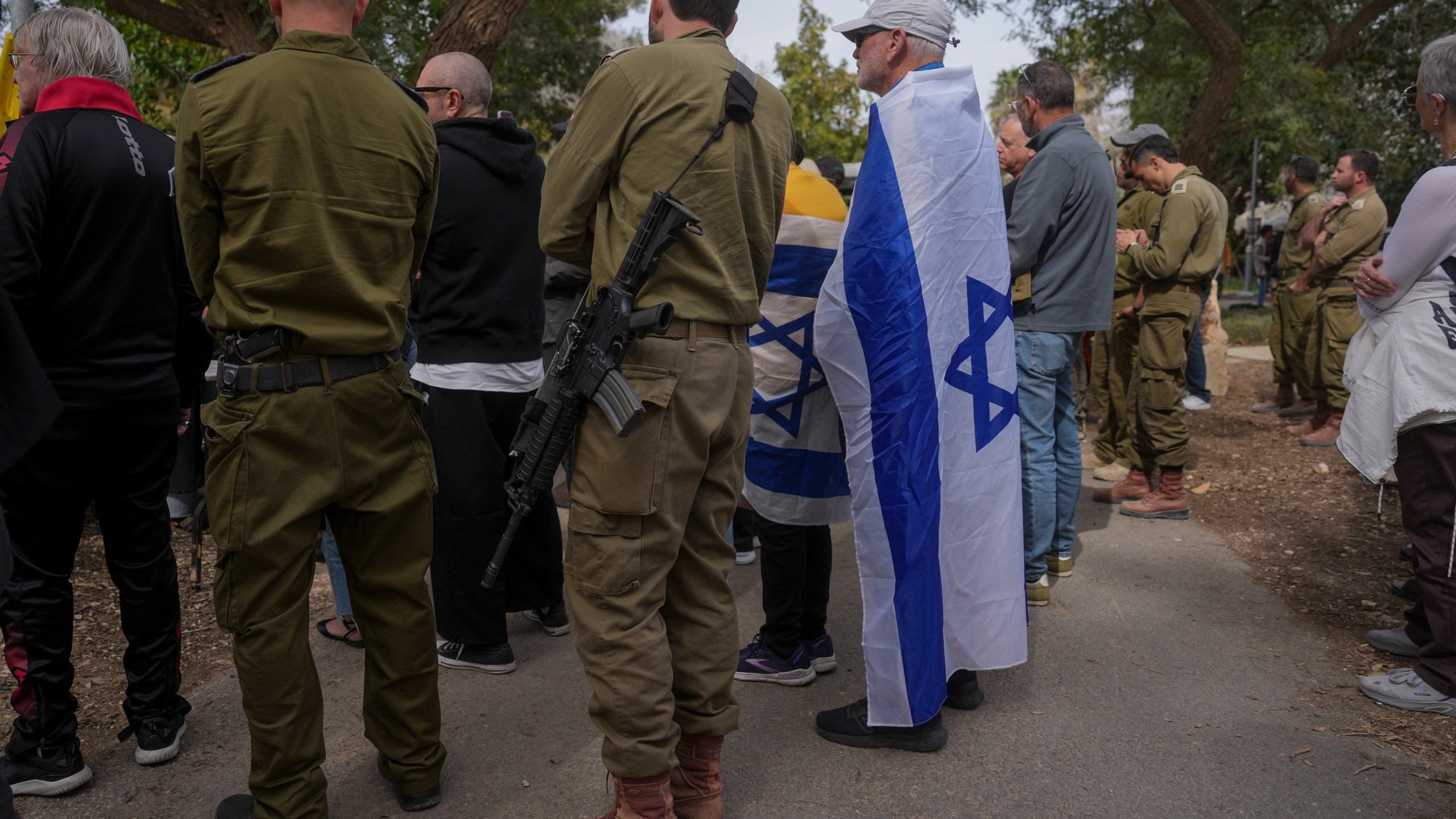 Mourners attend the funeral of Itzhak Elgarat, a slain hostage who was held captive by Hamas in Gaza, in Kibbutz Nir Oz, Israel, on Monday, March 3, 2025. (AP Photo/Ohad Zwigenberg)