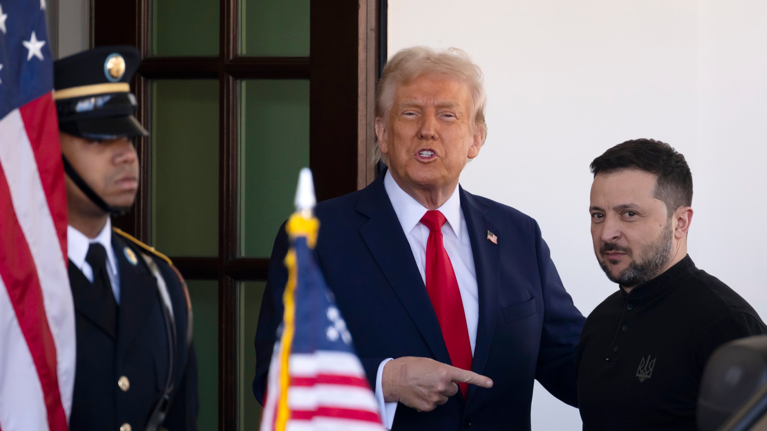 Ukraine President Volodymyr Zelenskyy, right, is greeted by President Donald Trump, center, as he arrives at the White House in Washington, Friday, Feb. 28, 2025. (AP Photo/Ben Curtis)