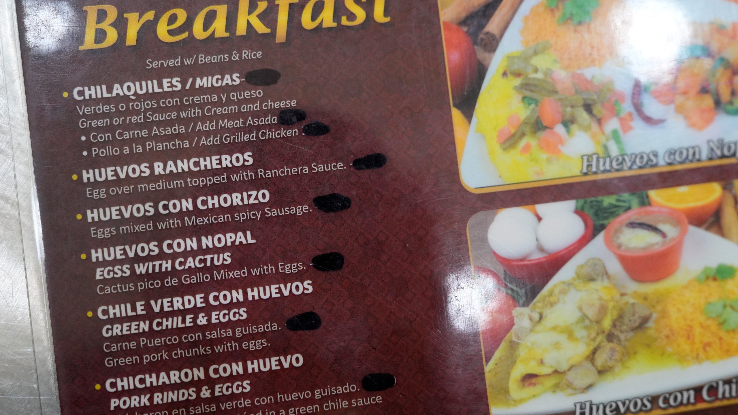 The prices on the menu are blacked out at Birrieria Chalio Mexican Restaurant in Fort Worth, Texas, Thursday, Feb. 13, 2025. (AP Photo/LM Otero)