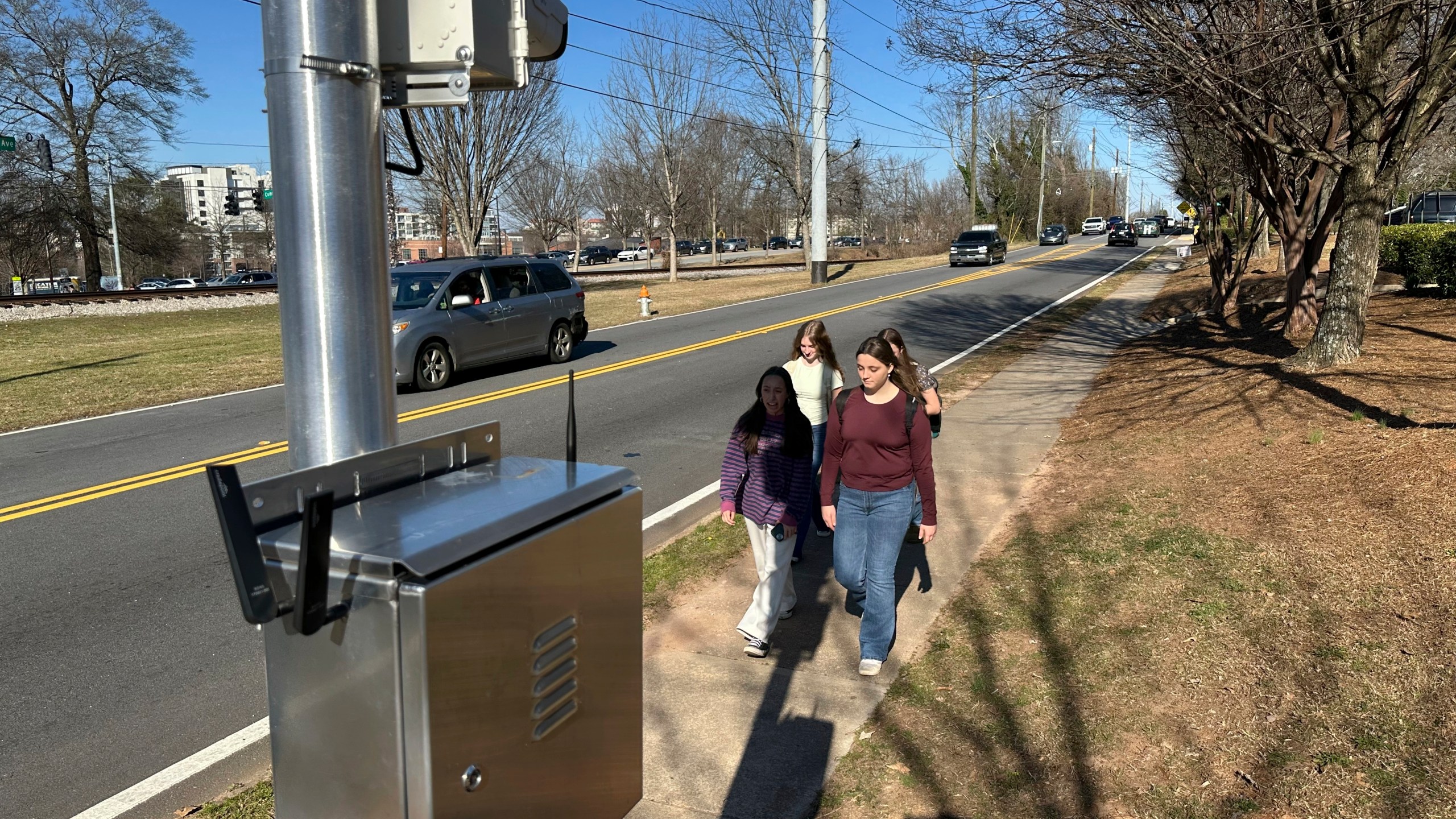 Students walk home past an automated speed camera outside Beacon Hill Middle School in Decatur, Ga., on Tuesday, Feb. 25, 2025. (AP Photo/Jeff Amy)